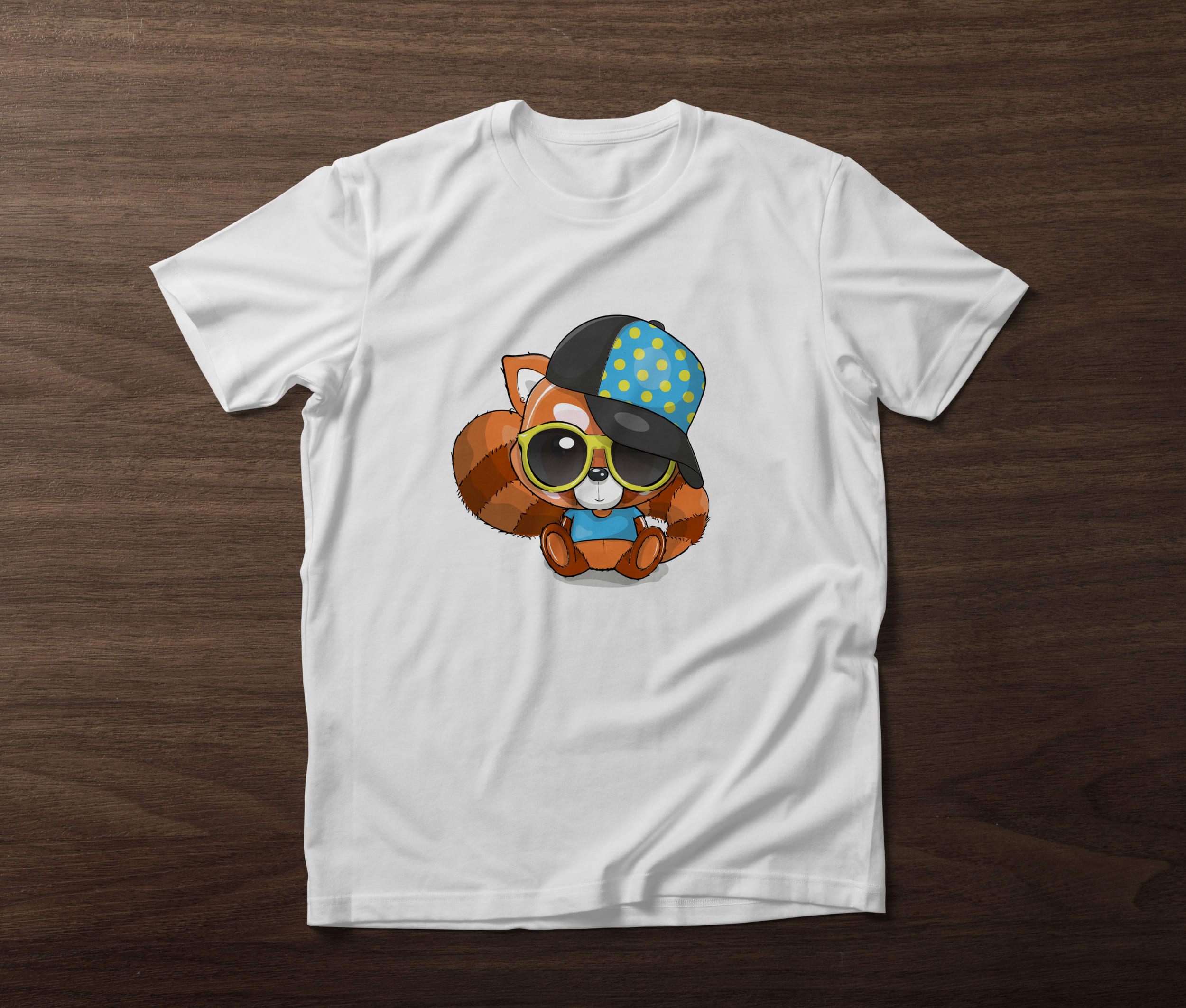 White t-shirt with a red panda in a cap and glasses on a wooden background.