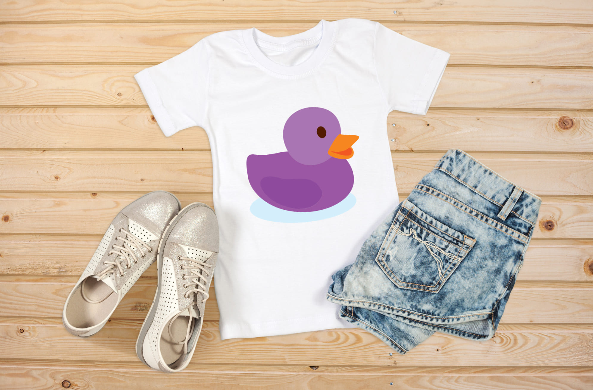 Picture of a white t-shirt with an adorable rubber duck print in purple.