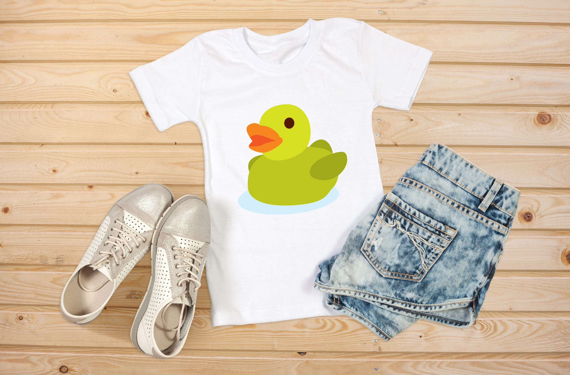 Image of a white T-shirt with an adorable rubber duck print in light green