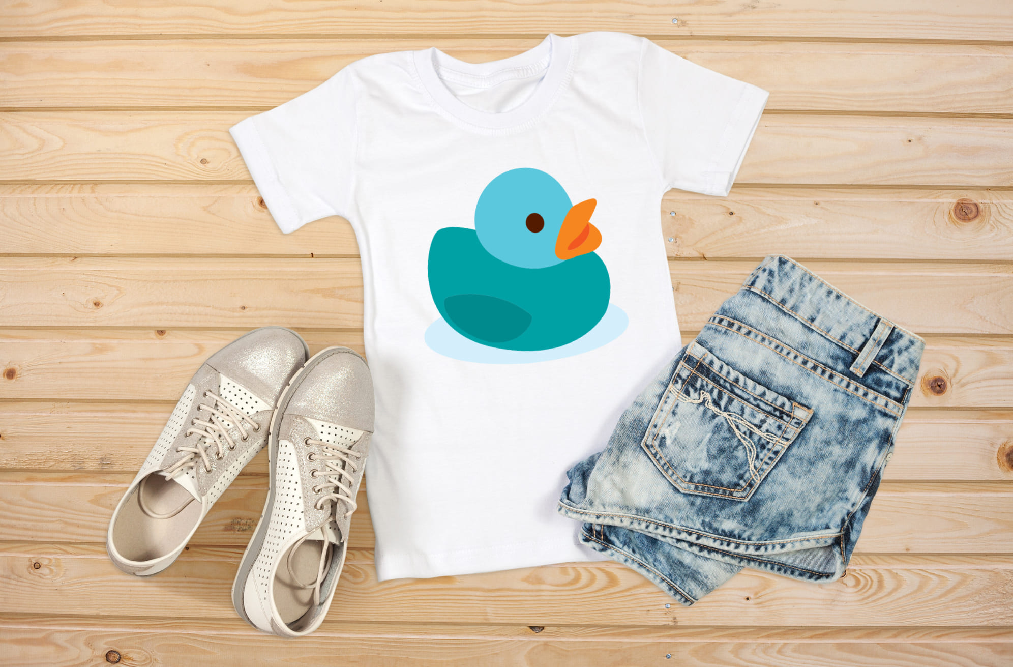 Image of a white t-shirt with an amazing rubber duck print in green.