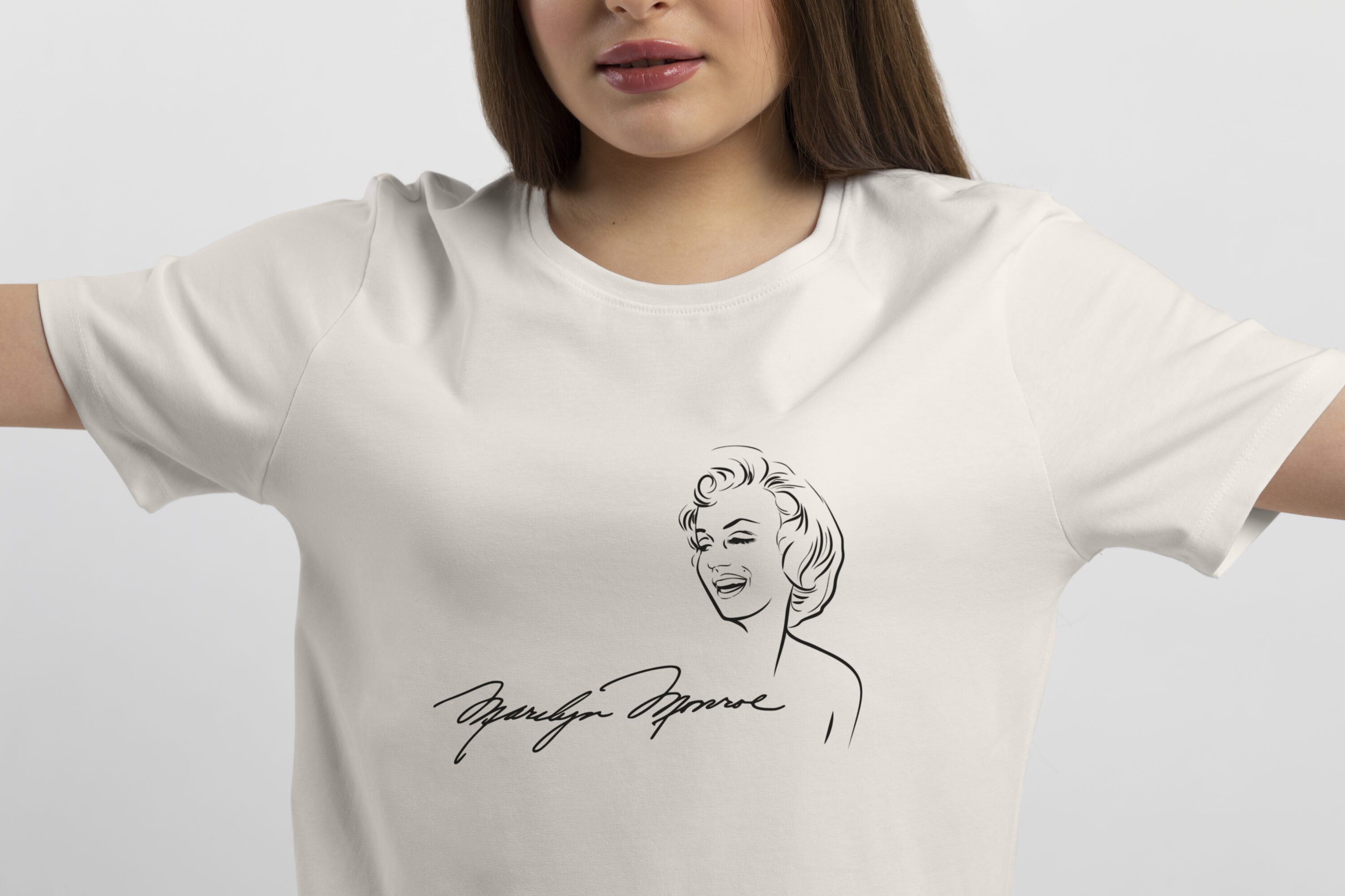 Image of a white t-shirt with a gorgeous print of Marilyn Monroe and her signature.