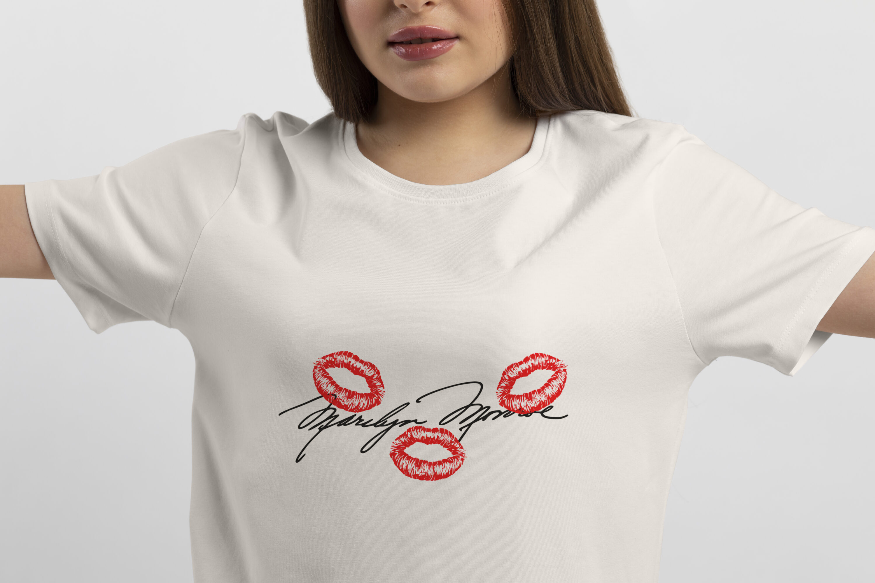 Image of a white t-shirt with a colorful print of Marilyn Monroe's signature and her lips imprint.