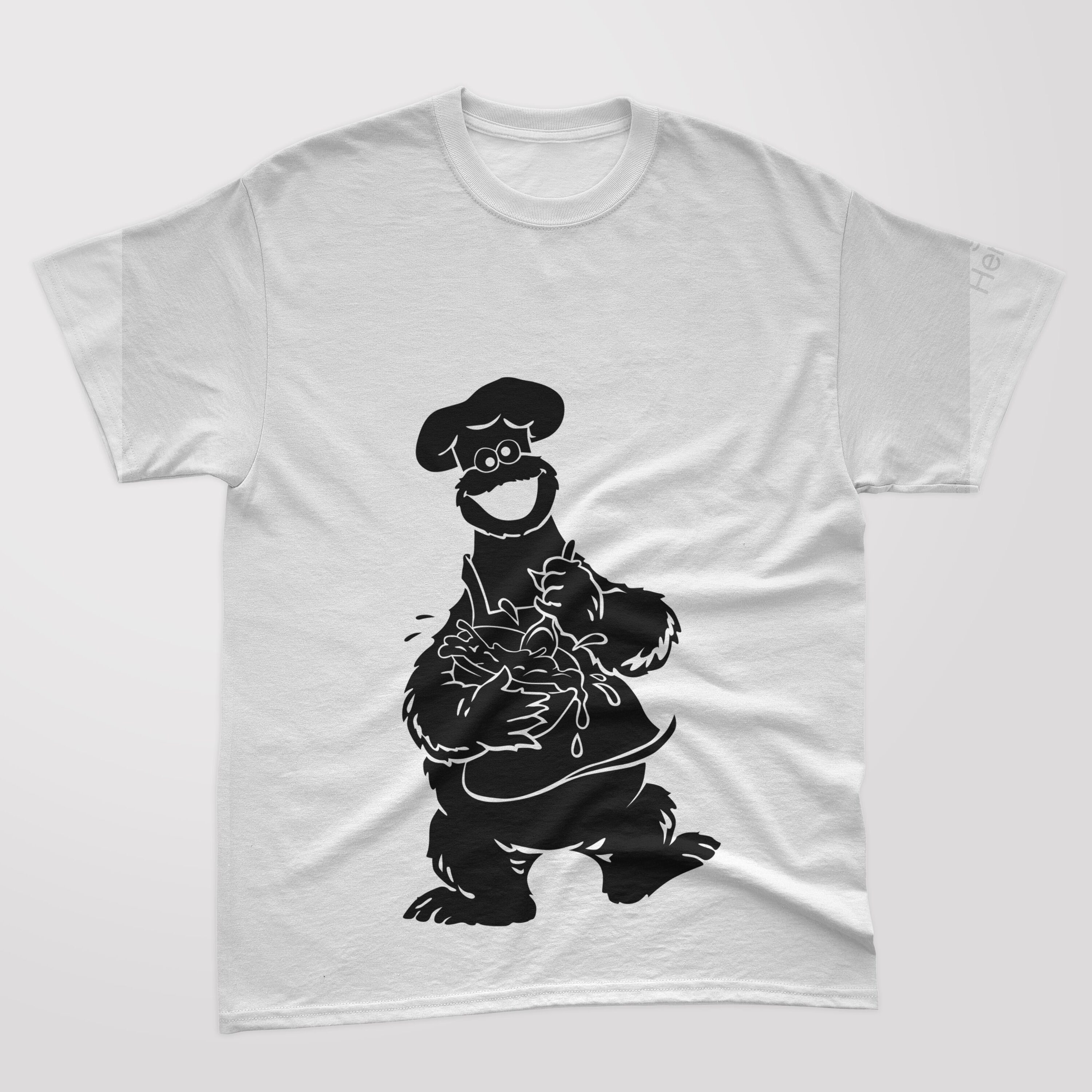 A white t-shirt with a black silhouette cookie monster, who cooks food.