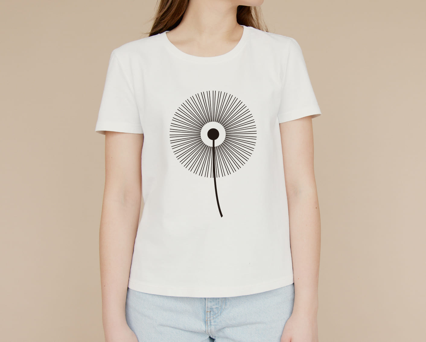 A white T-shirt with a black silhouette of a dandelion flower on a girl on a beige background.