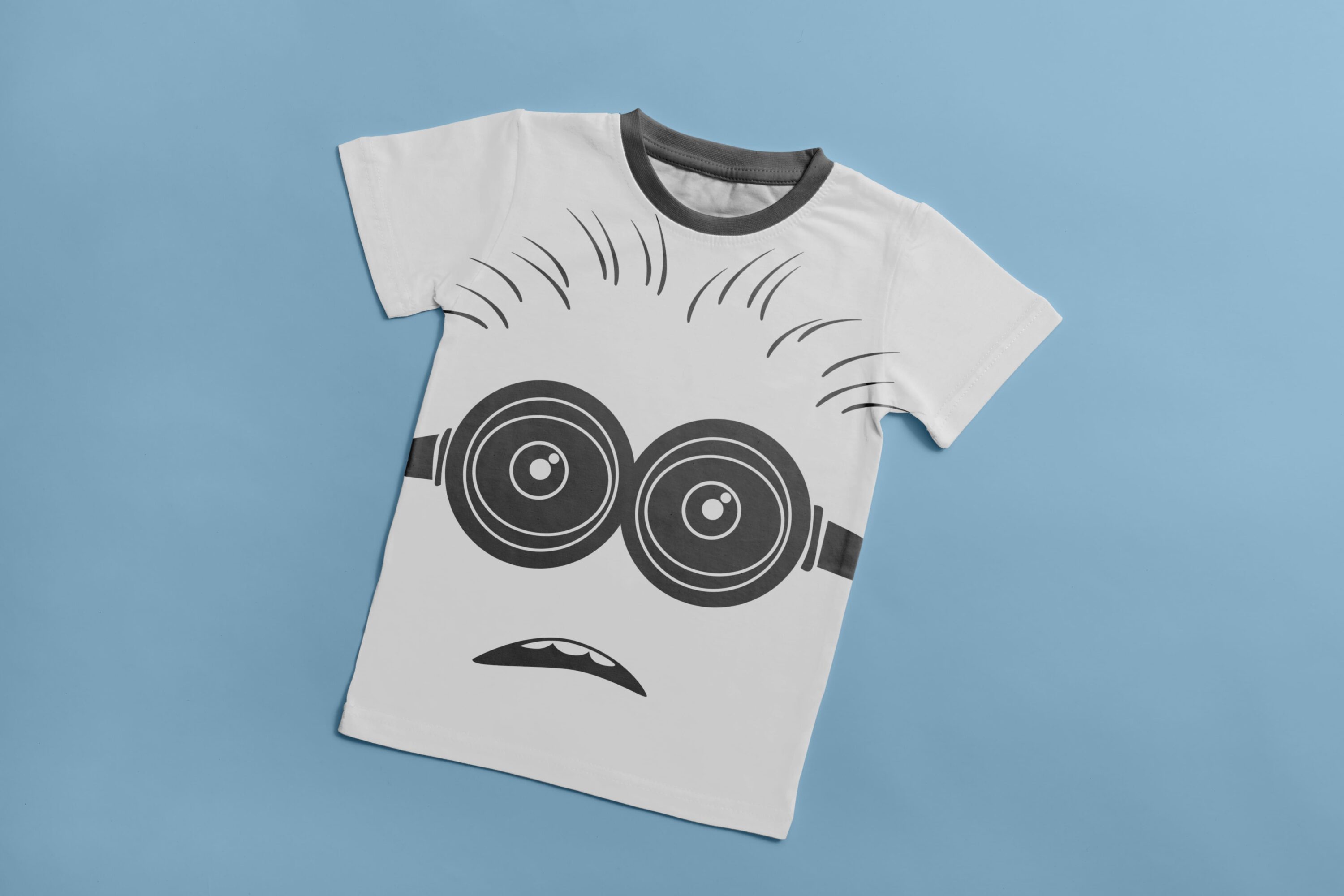 A white T-shirt with a gray collar and a gray silhouette of a puzzled minion.