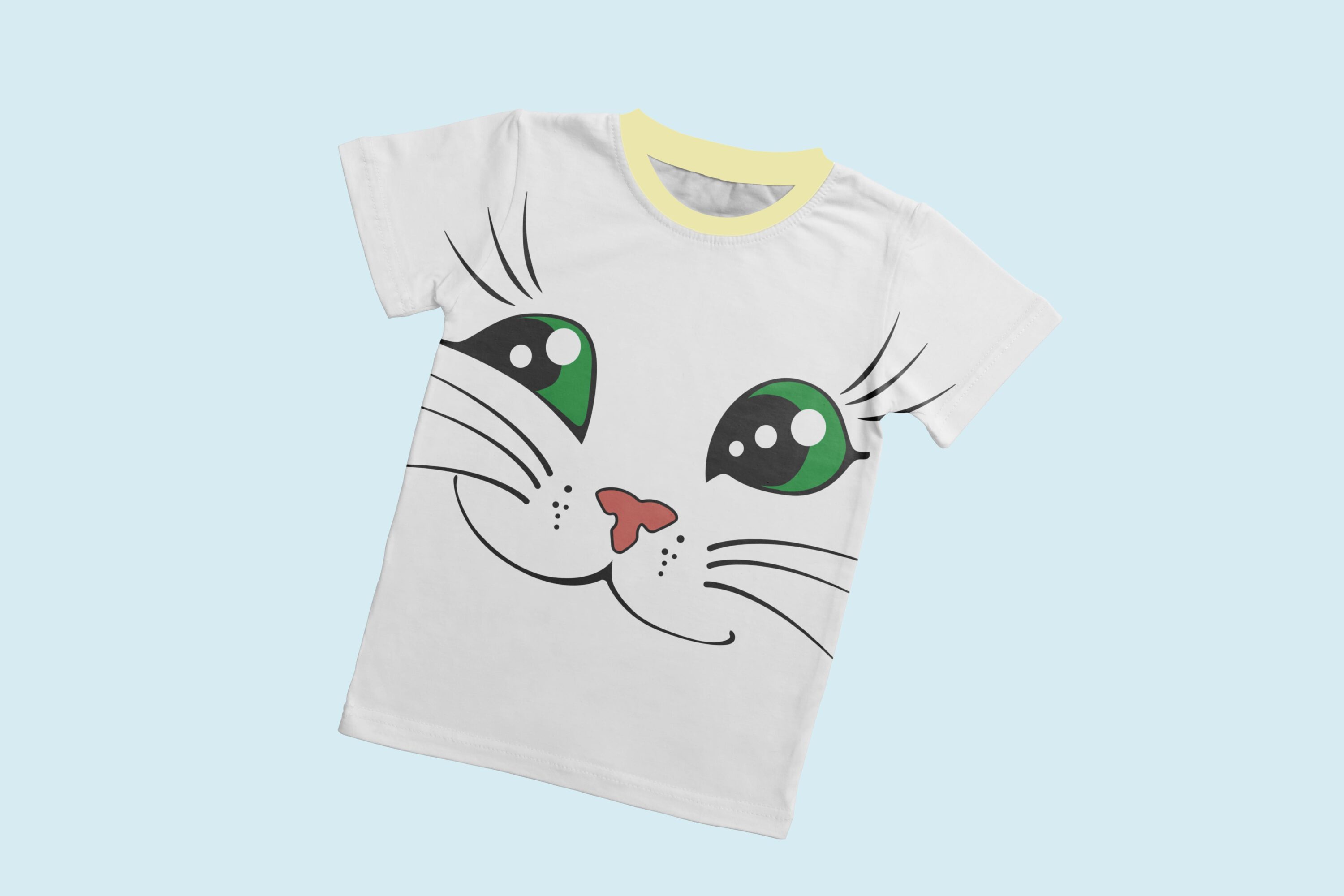 A white t-shirt with a light yellow collar and the face of a smiling cat with green eyes.