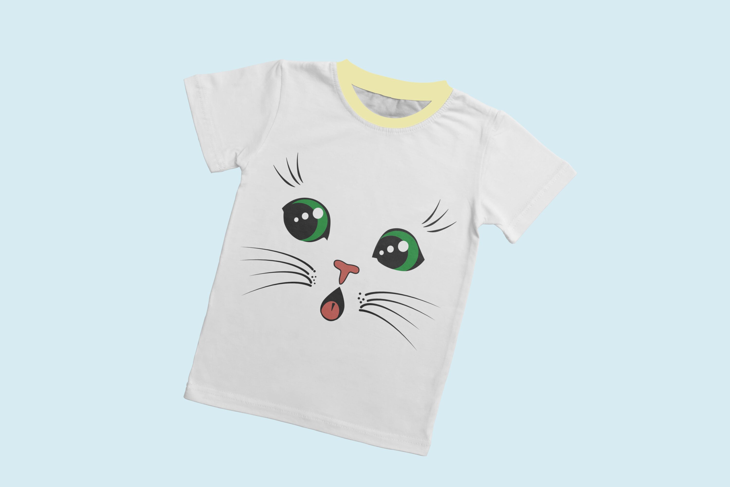A white t-shirt with a light yellow collar and the face of a surprised cat with green eyes.