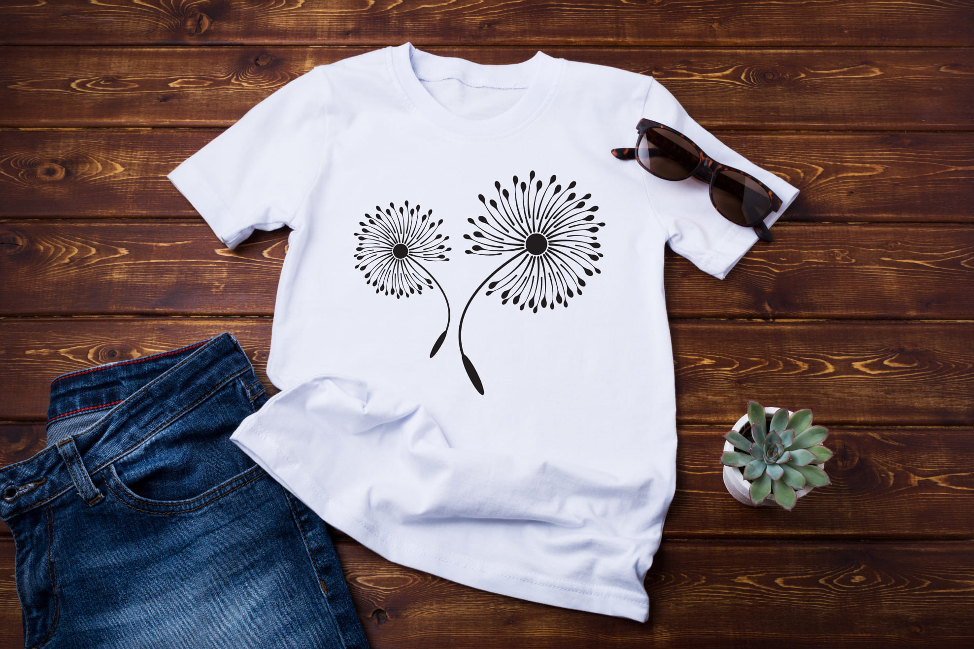 T-shirt image with enchanting print of dandelions in black color.