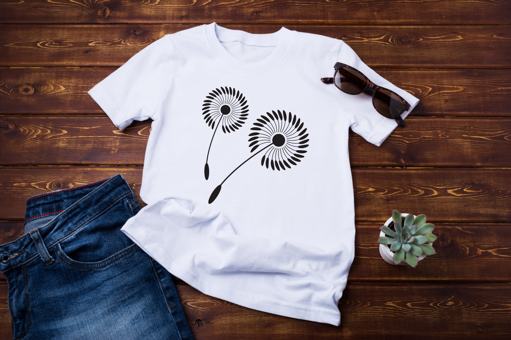 T-shirt image with unique dandelion print in black color.