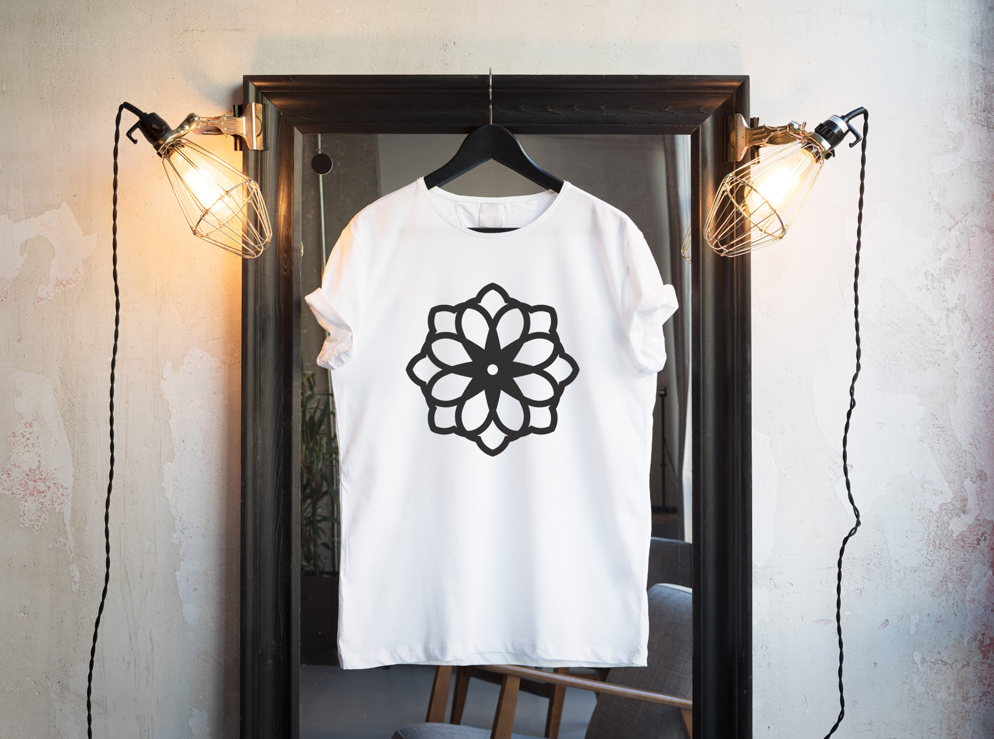 Black outline lotus on a white t-shirt.