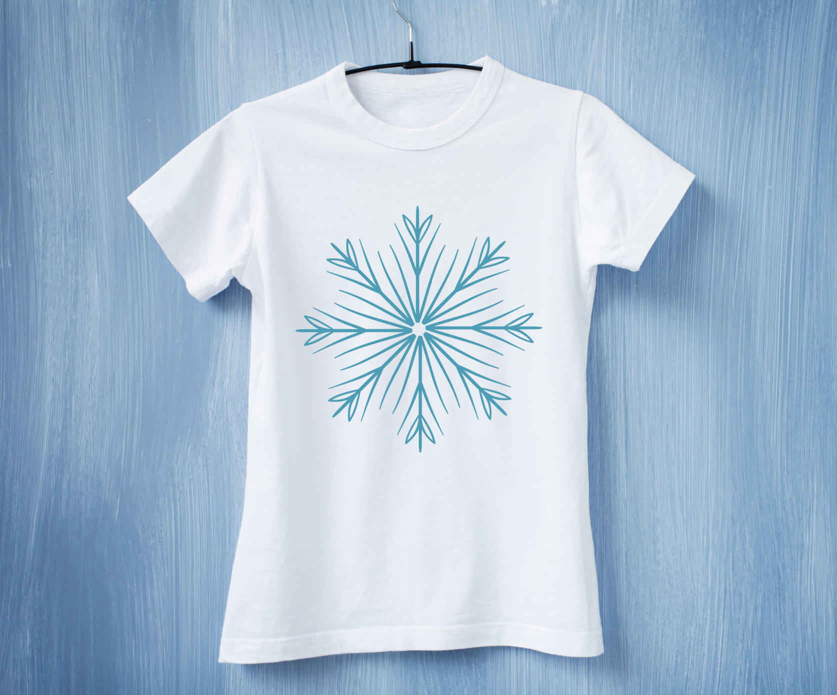 Delicate snowflake ornament on a white t-shirt.
