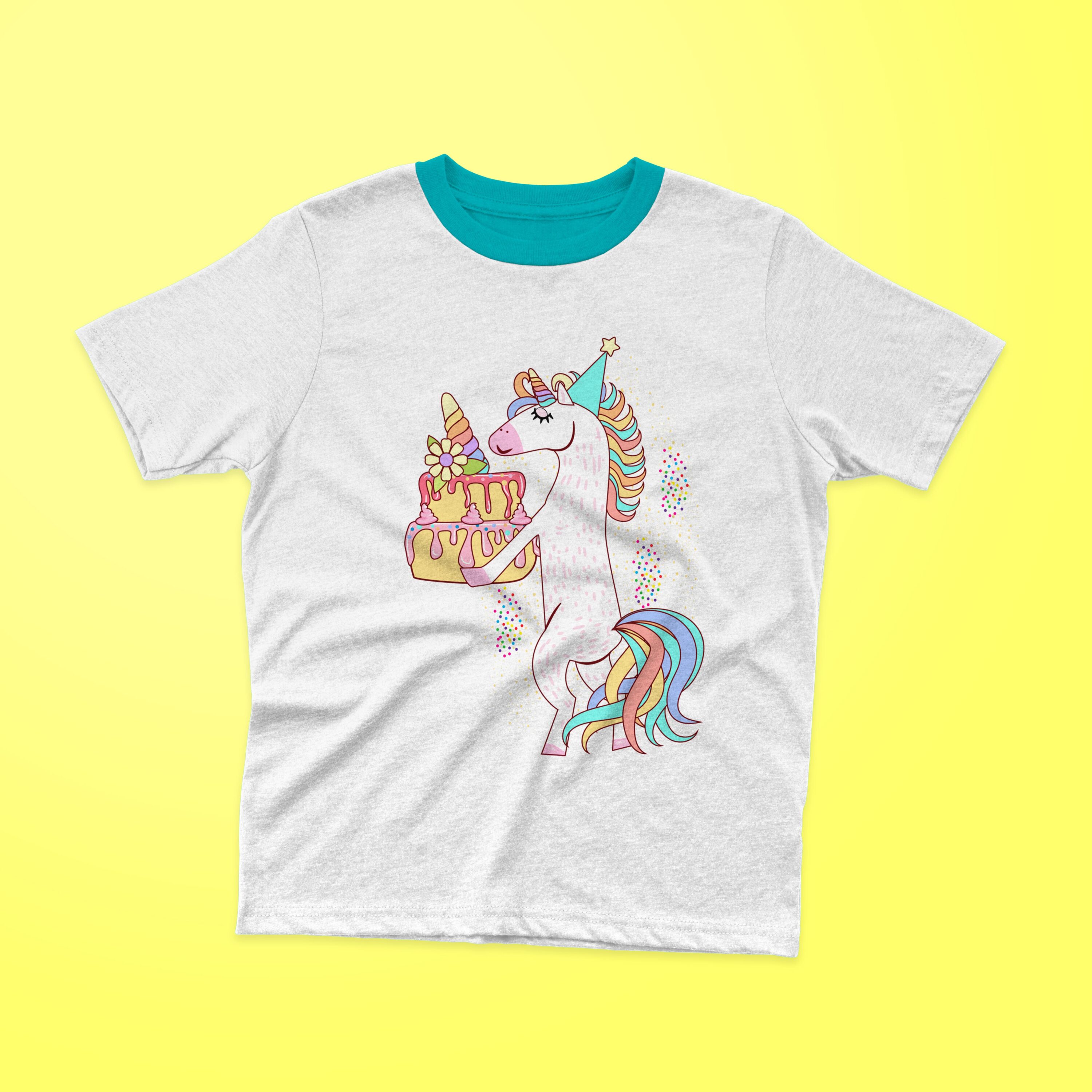 White t-shirt with a turquoise collar and a unicorn holding a birthday cake on a yellow background.