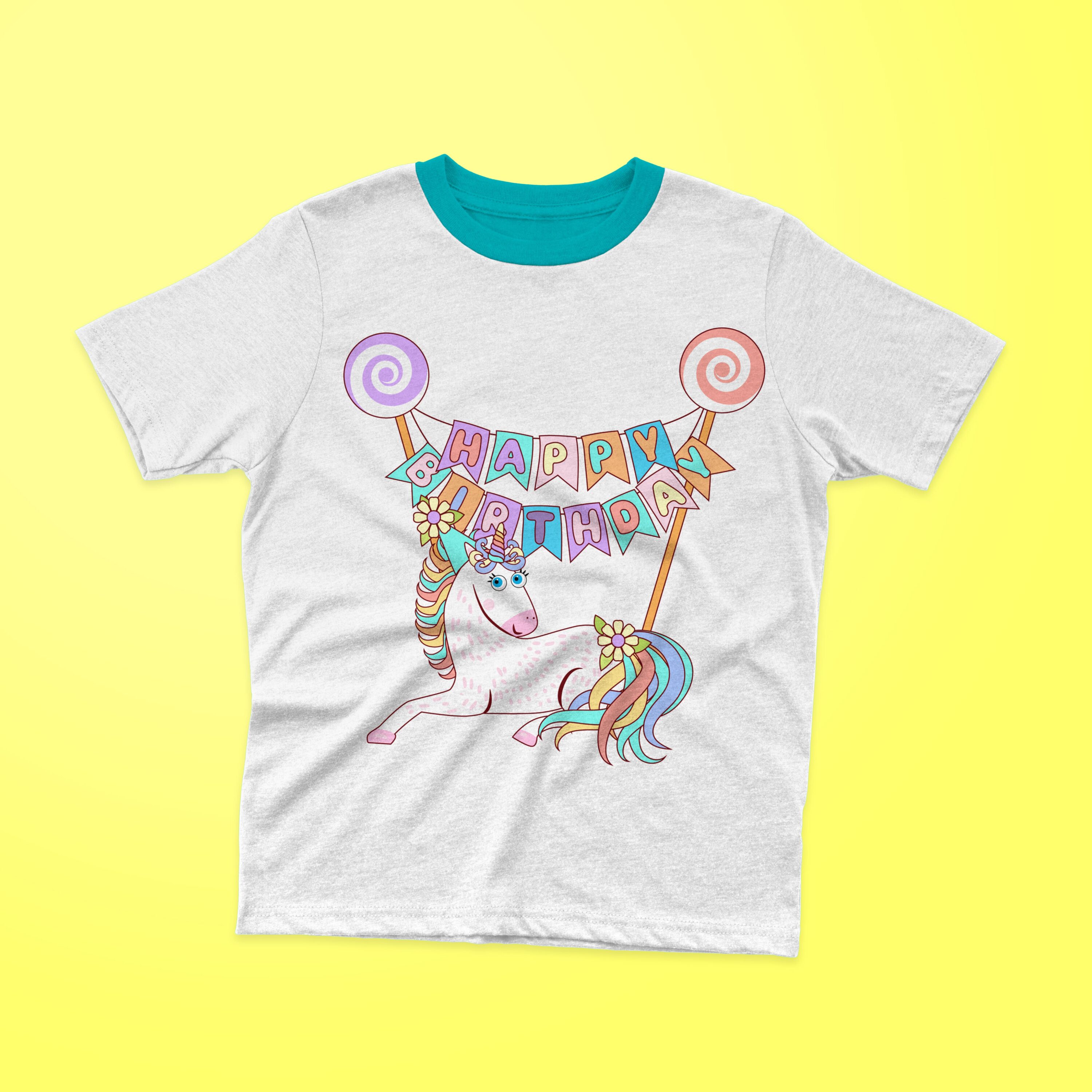 White t-shirt with a turquoise collar and a lying unicorn with colorful lettering "HAPPY BIRTHDAY" on a yellow background.