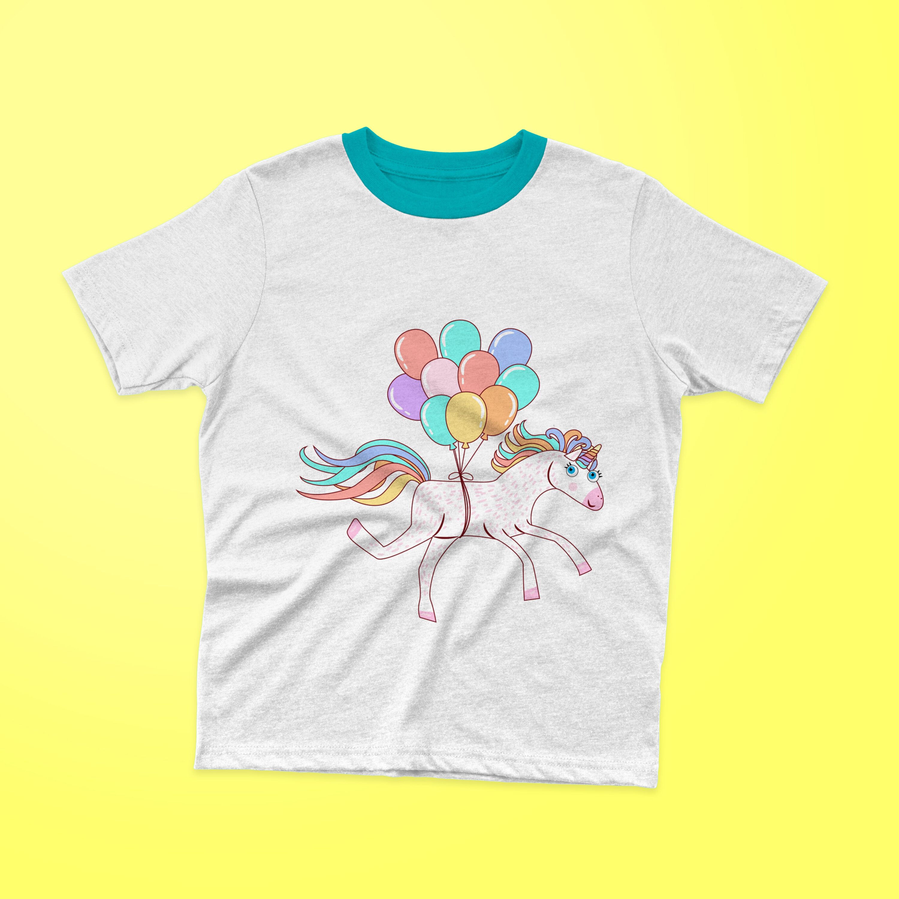 White t-shirt with a turquoise collar and a flying unicorn with colorful balloons on a yellow background.