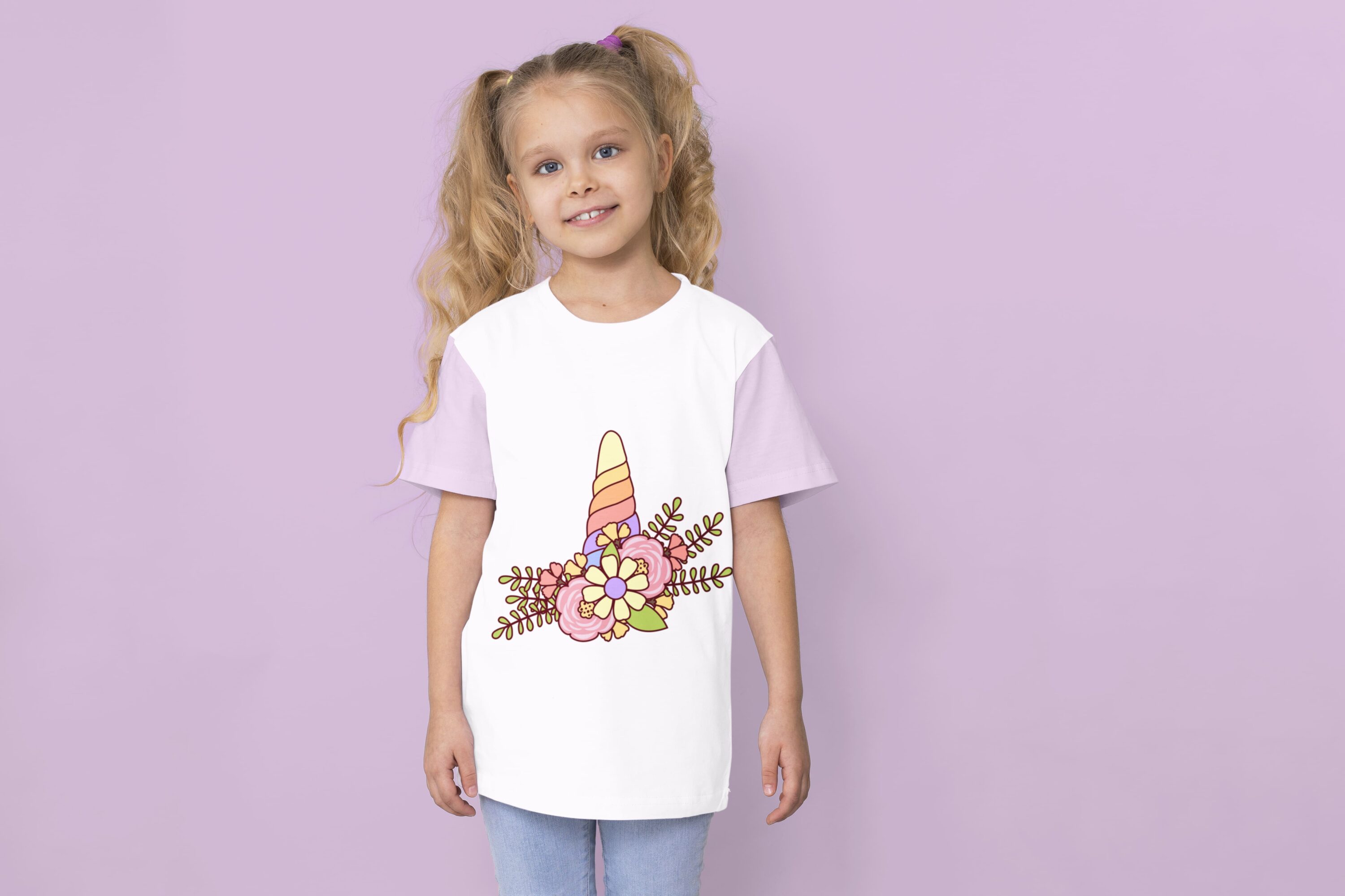 A white t-shirt with lavender sleeves and a colorful unicorn horn on a girl against a lavender background.