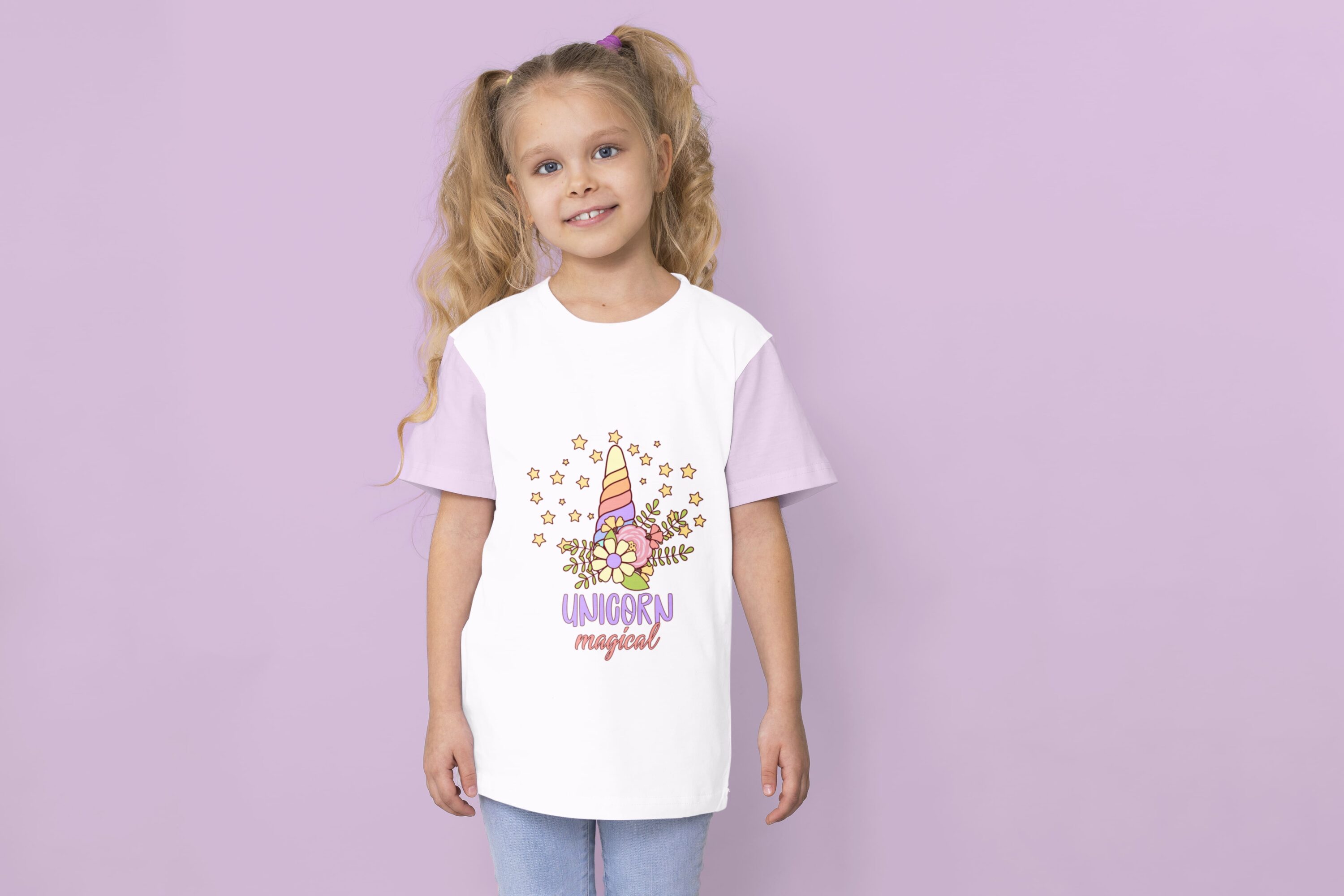 A white t-shirt with lavender sleeves and a colorful unicorn horn with stars and lavender lettering "UNICORN" with pink lettering "magical" on a girl against a lavender background.