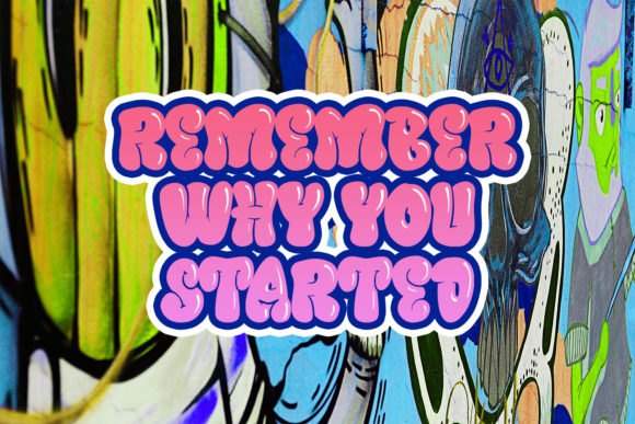Pink and purple "Remember why you started" lettering in graffiti font on a graffiti background.