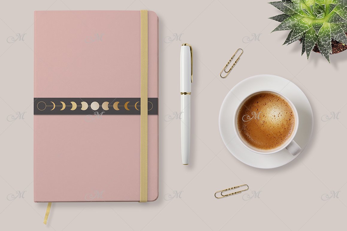 Pink notebook mockup with a yellow rubber band bookmark, a white pen and a white cup of coffee on a white background.