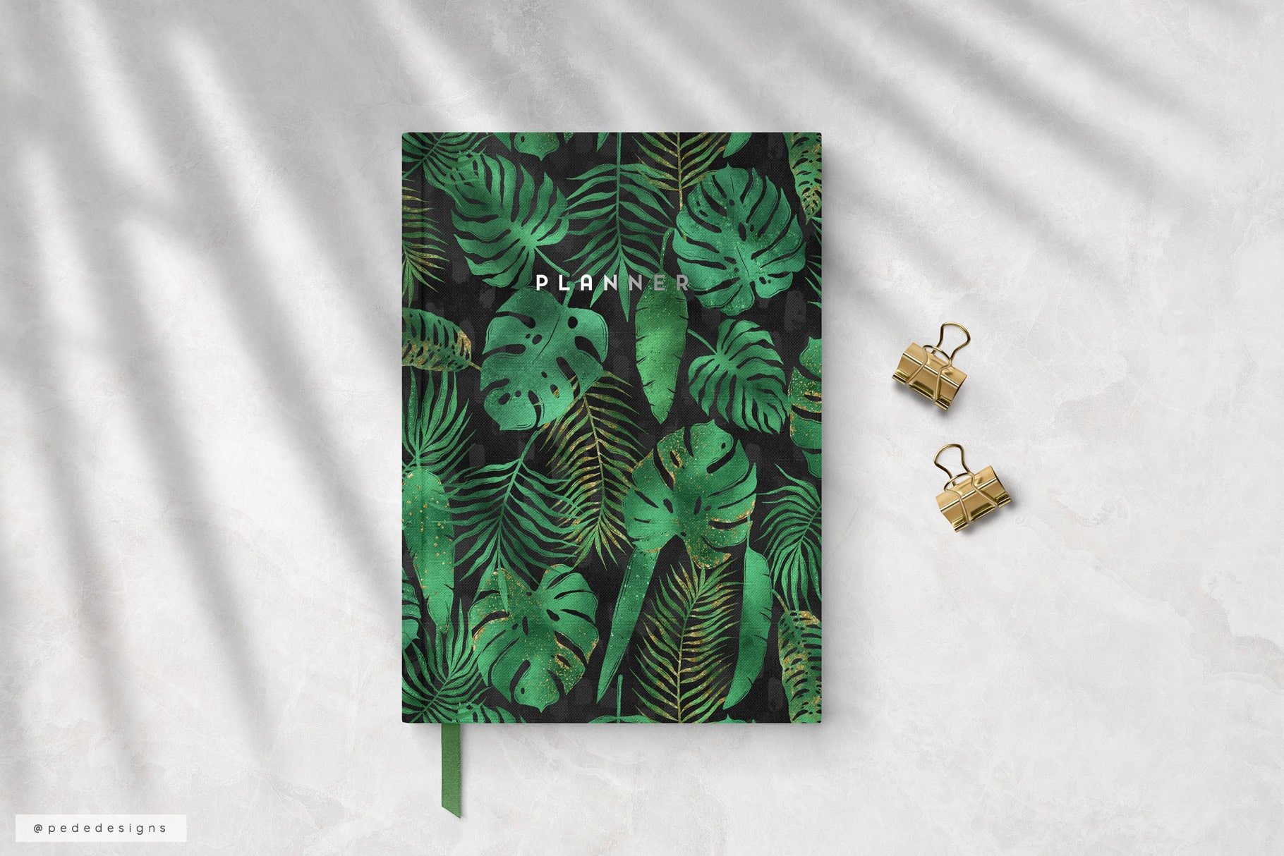 Dark notebook with the big tropical leaves.