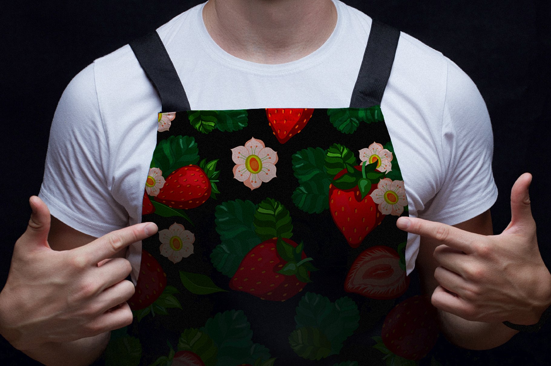 Black kitchen apron with strawberry illustrations on a man.