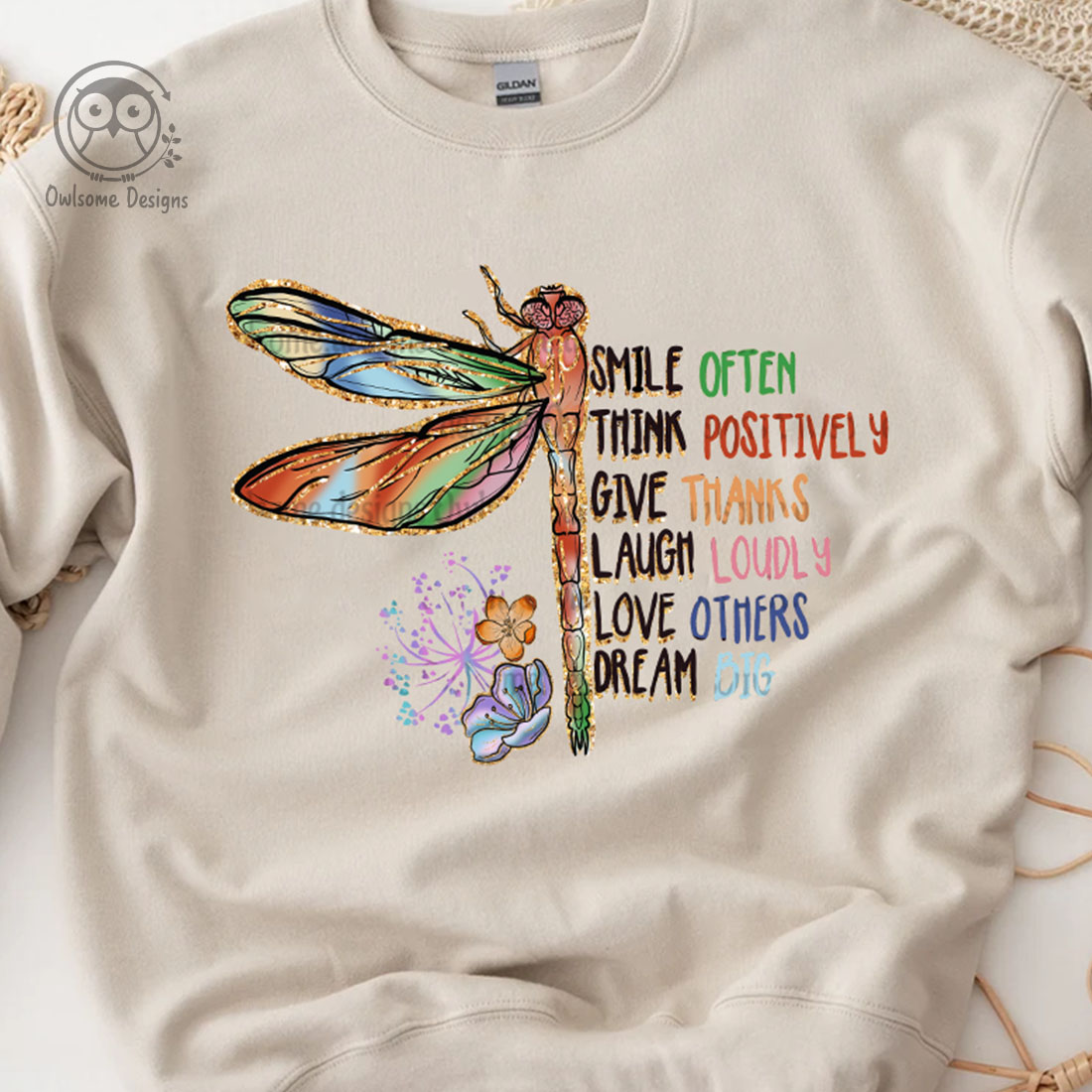 Image of a sweatshirt with a unique dragonfly print and slogan.
