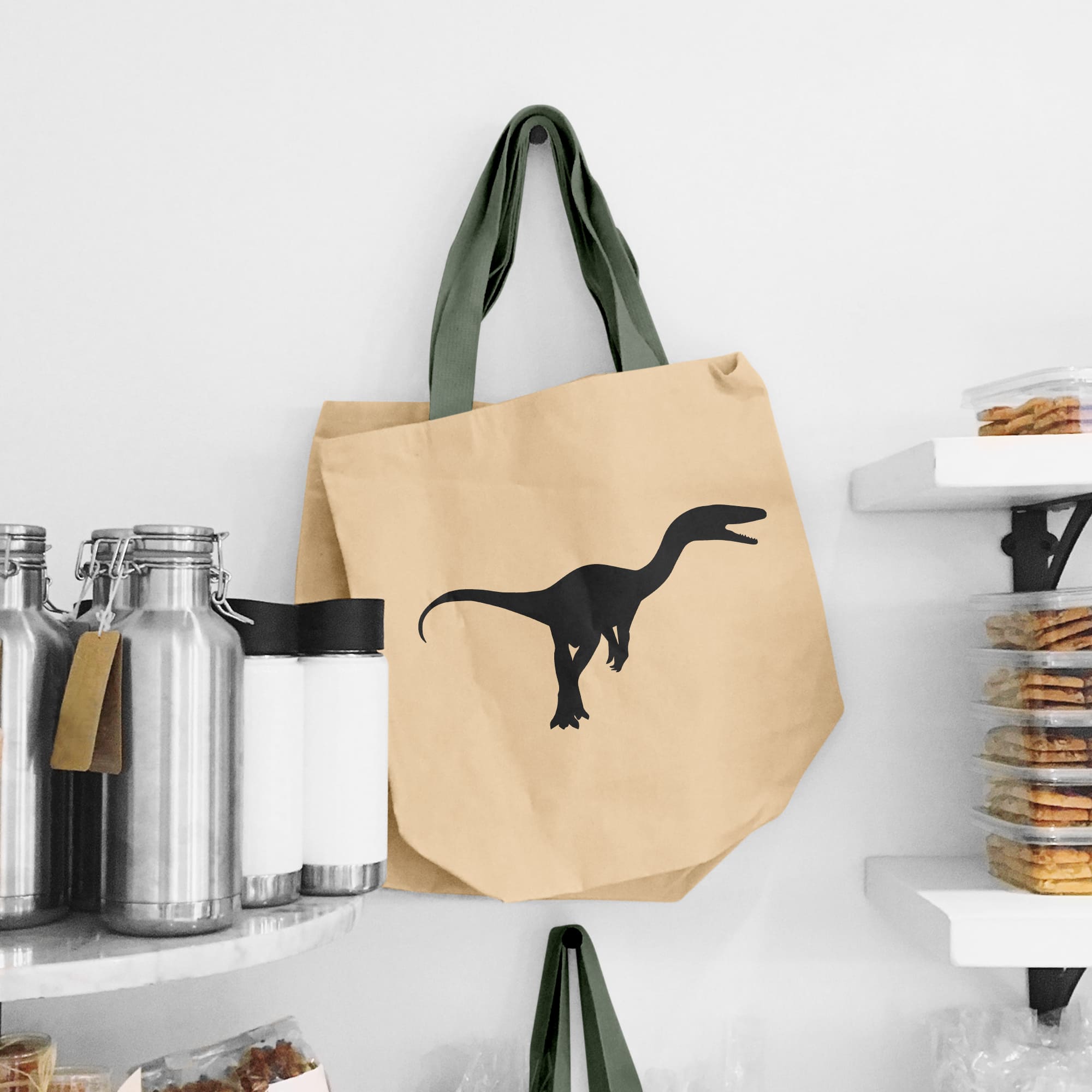 Brown paper bag with a black dinosaur on it.