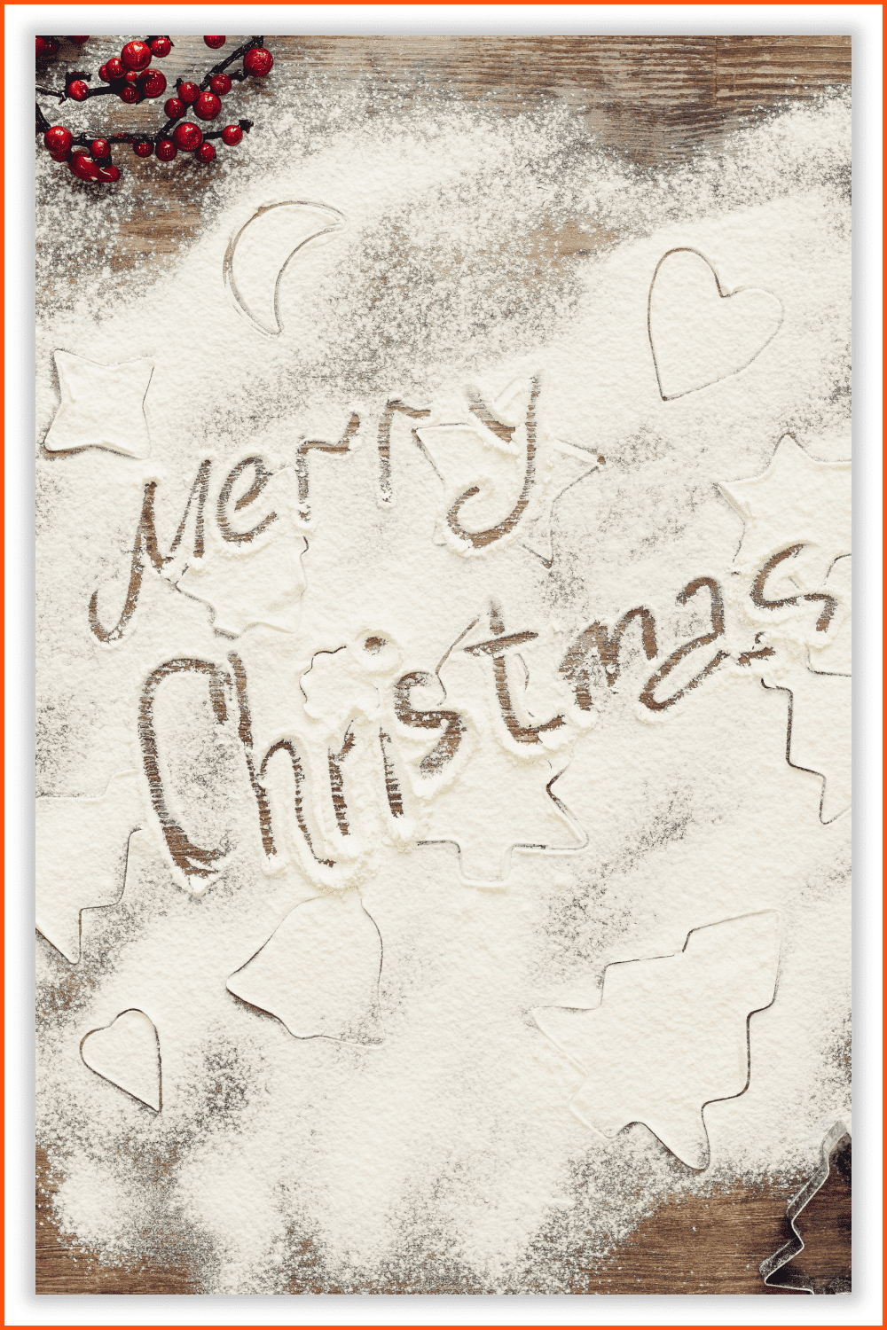 Photo of a Merry Christmas inscription in flour on the table.