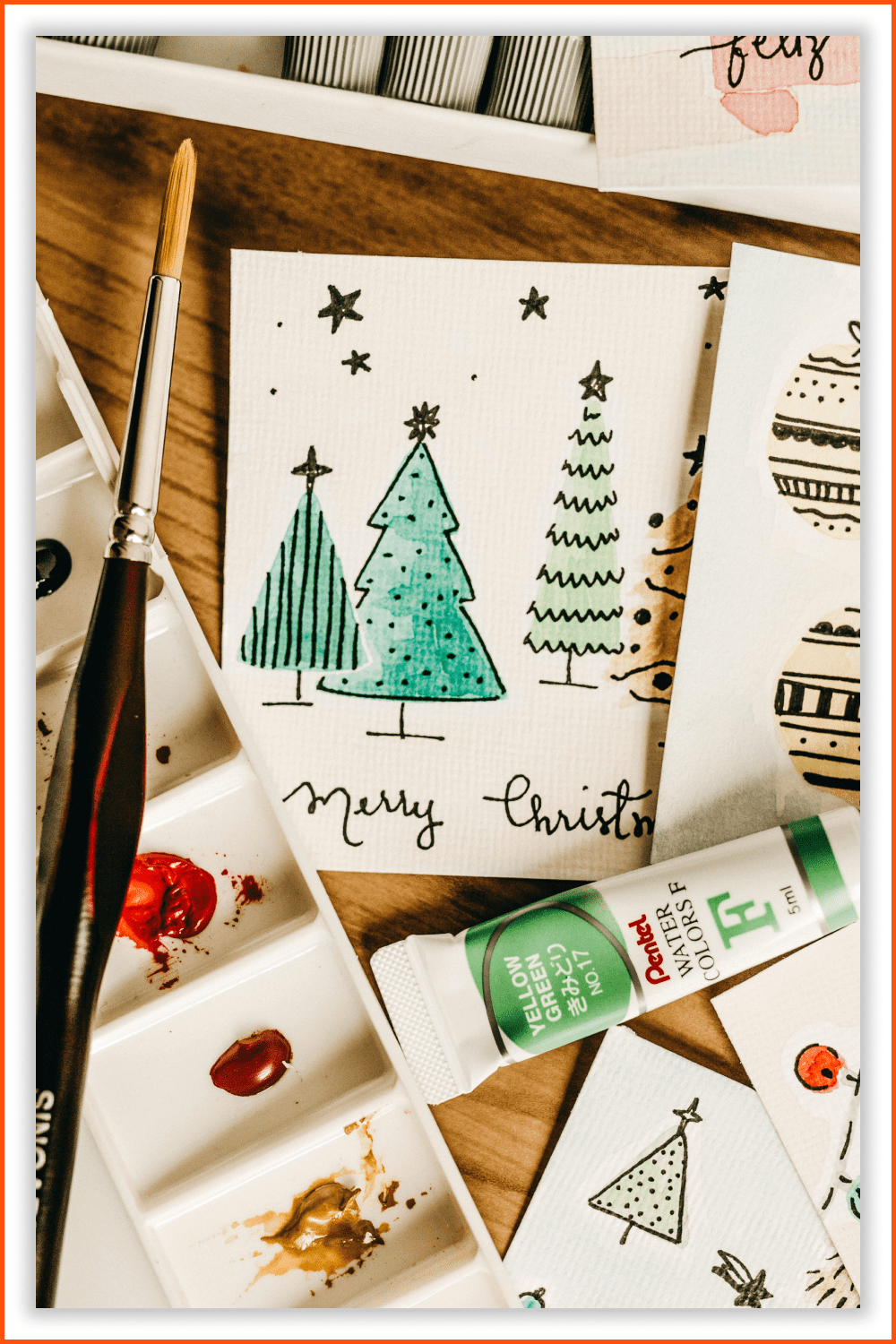 Photo of a cards with simple festive designs and painting stuff.