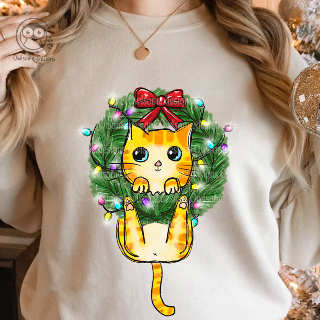 Image of a sweatshirt with an adorable cat print on a Christmas tree wreath.