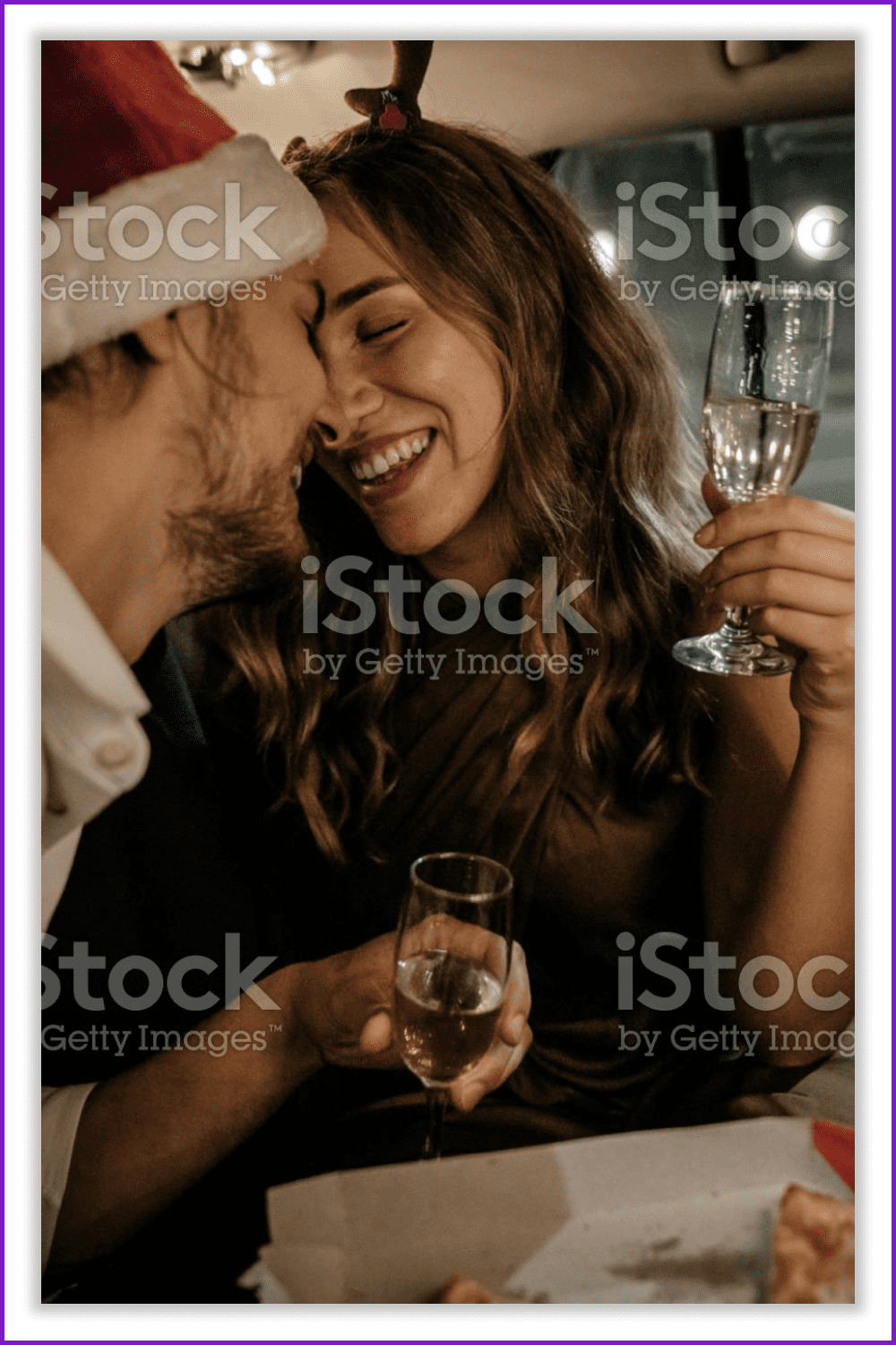 Smiling couple in love holding glasses of champagne.