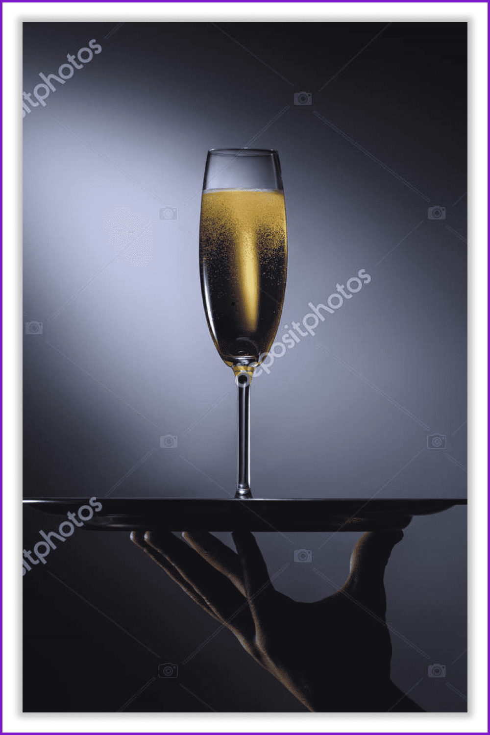Glass of champagne on a tray on a dark background.