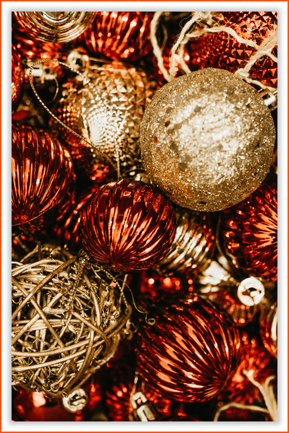 Photo of many baubles of different shapes in red and golden colors.