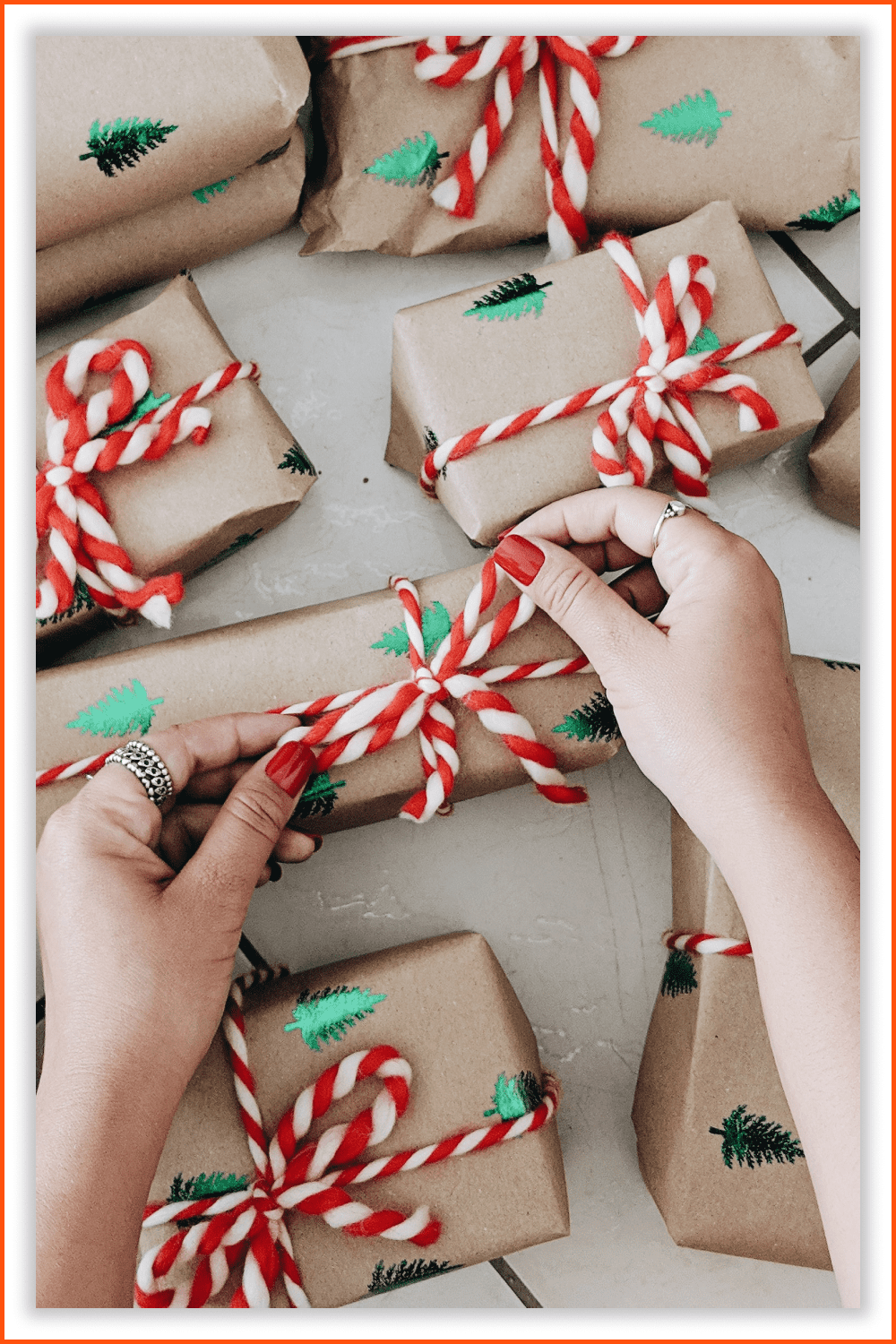 Gift boxes with Christmas tree stamps and a rope in the style of candy canes.