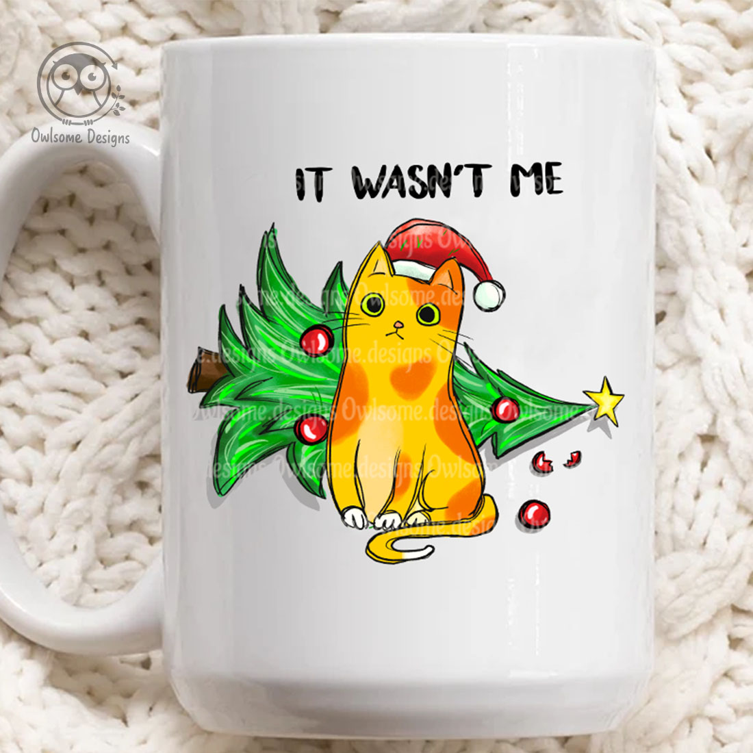 Image of a cup with a print of a cat knocking over a Christmas tree.