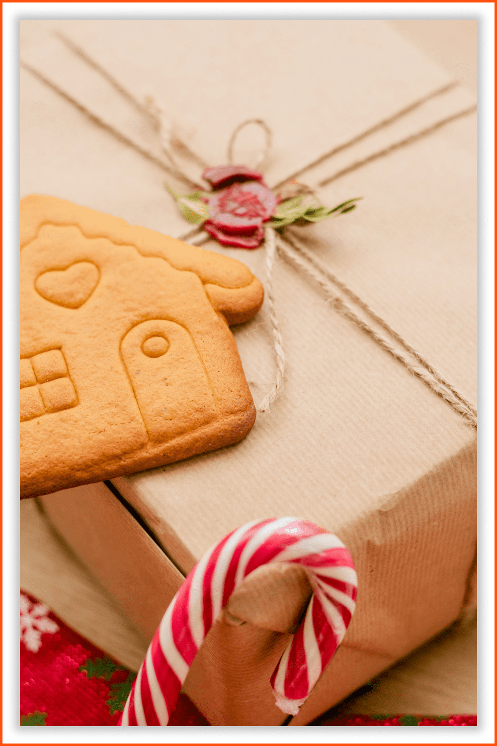 Photo of a cookie in a house shape, a candy cane, and a big red sock.
