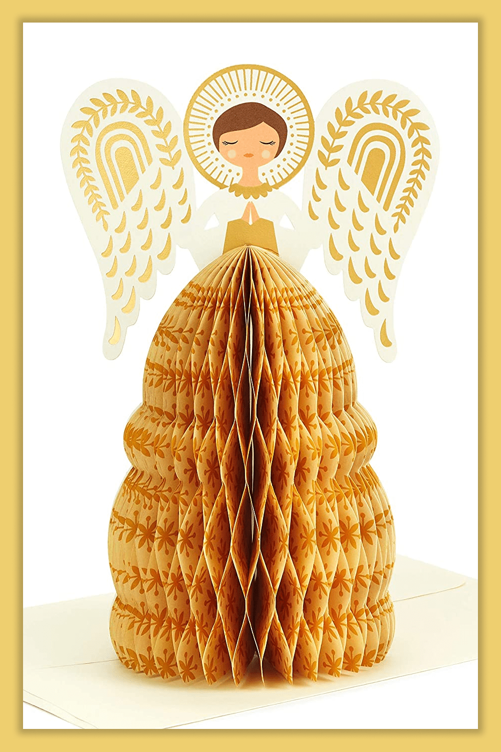 Greeting card with a golden paper Christmas tree and an angel.