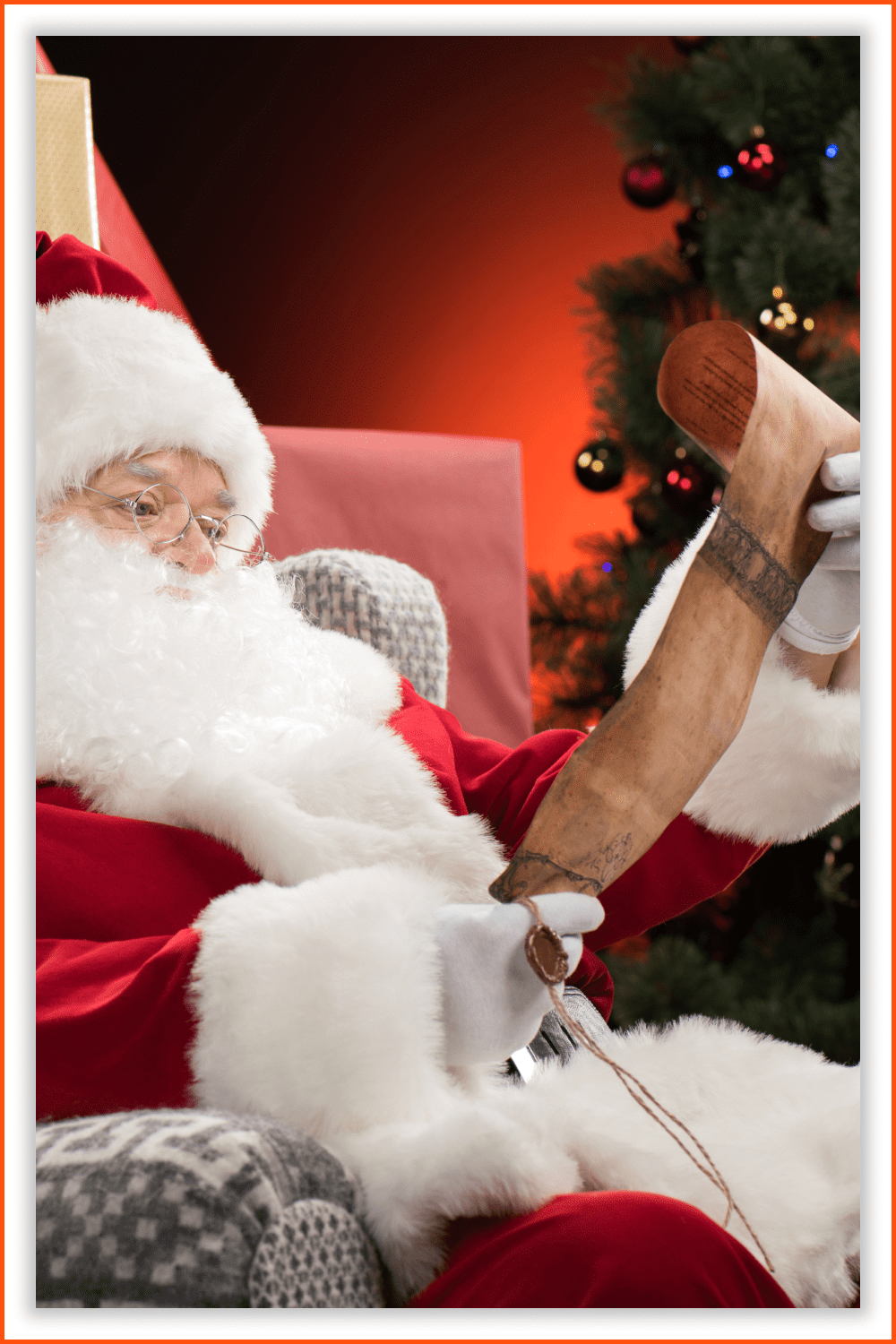 Santa reads the children's wishes among the presents and a big tree with decorations.