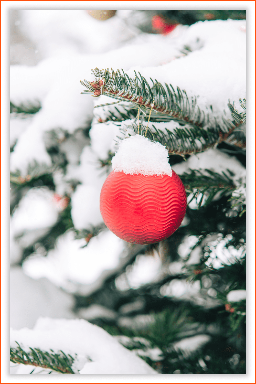 Branches of the Christmas tree with New Year's toys and snow.