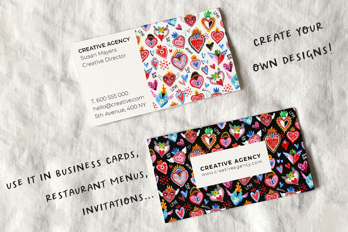 White and black visiting cards with black lettering "Creative agency" and hand-painted mexican hearts on a gray background.