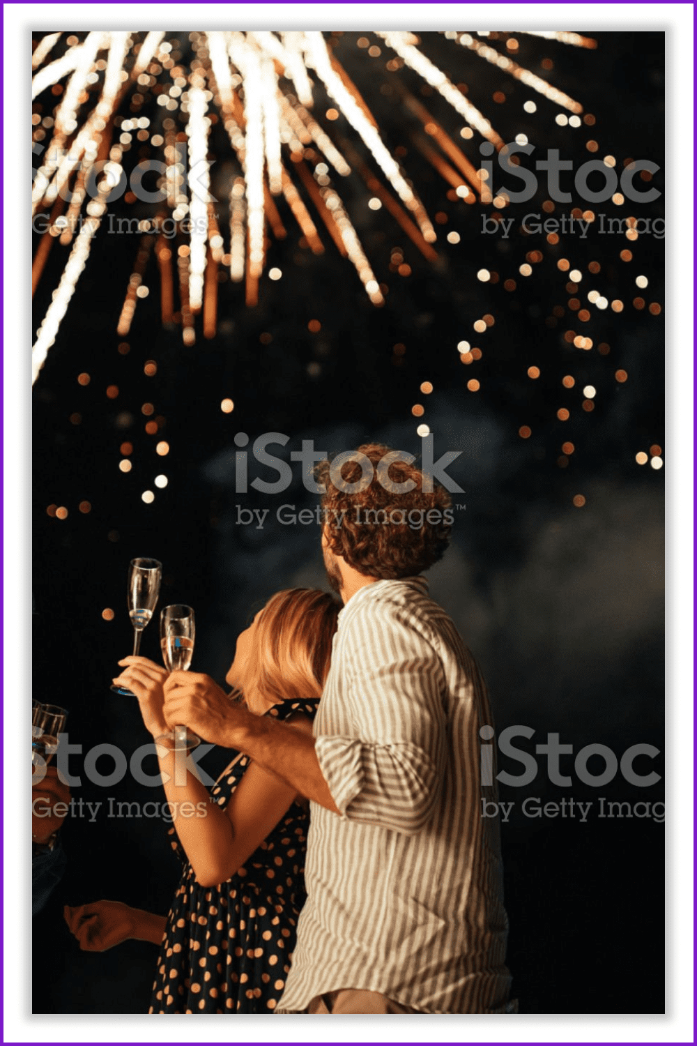 couple watching fireworks in the night sky.
