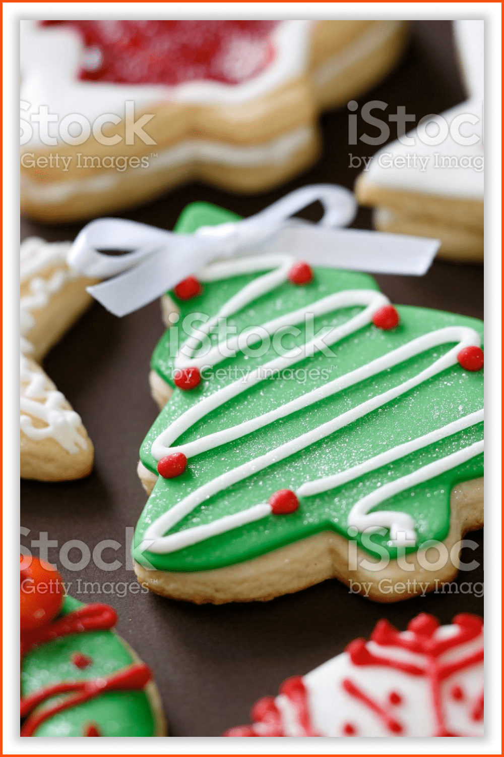 Cookies in different shapes of Christmas trees, wreaths, and stars.