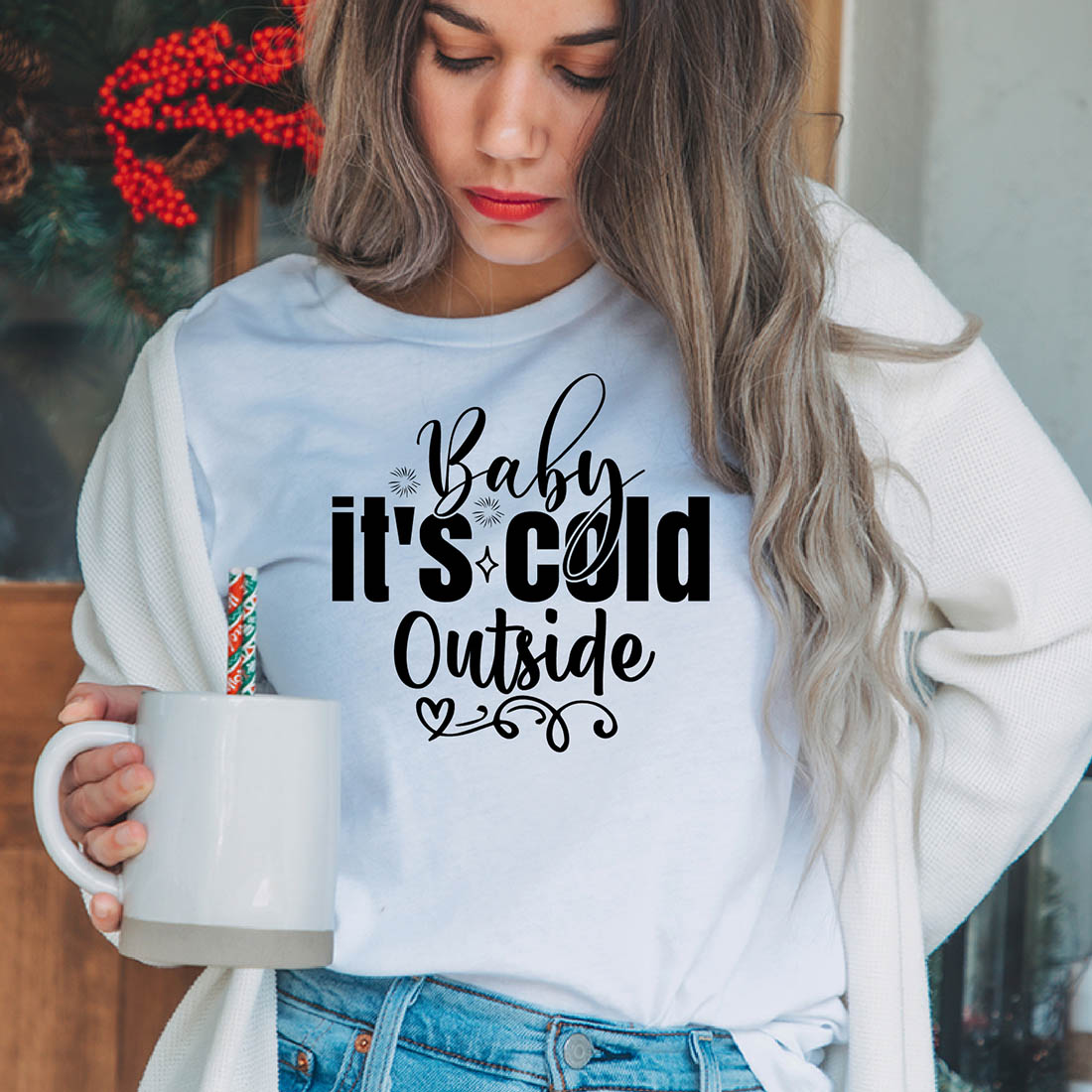 Image of a girl in a white T-shirt with a charming black inscription "baby its cold outside".