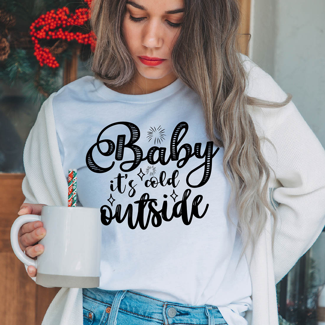 Image of a girl in a white t-shirt with a great inscription "baby its cold outside".