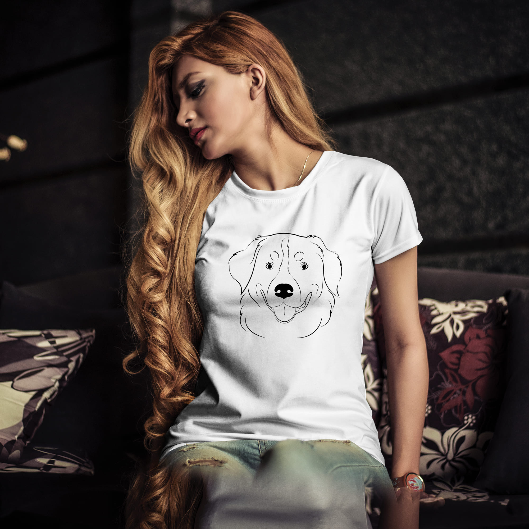 Woman sitting on a couch with a dog t - shirt on.