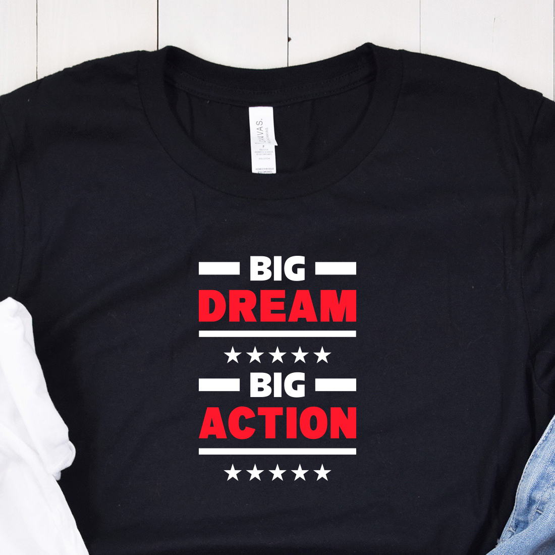 Image of a black t-shirt with the enchanting inscription "Big dream big action" in red and white colors.