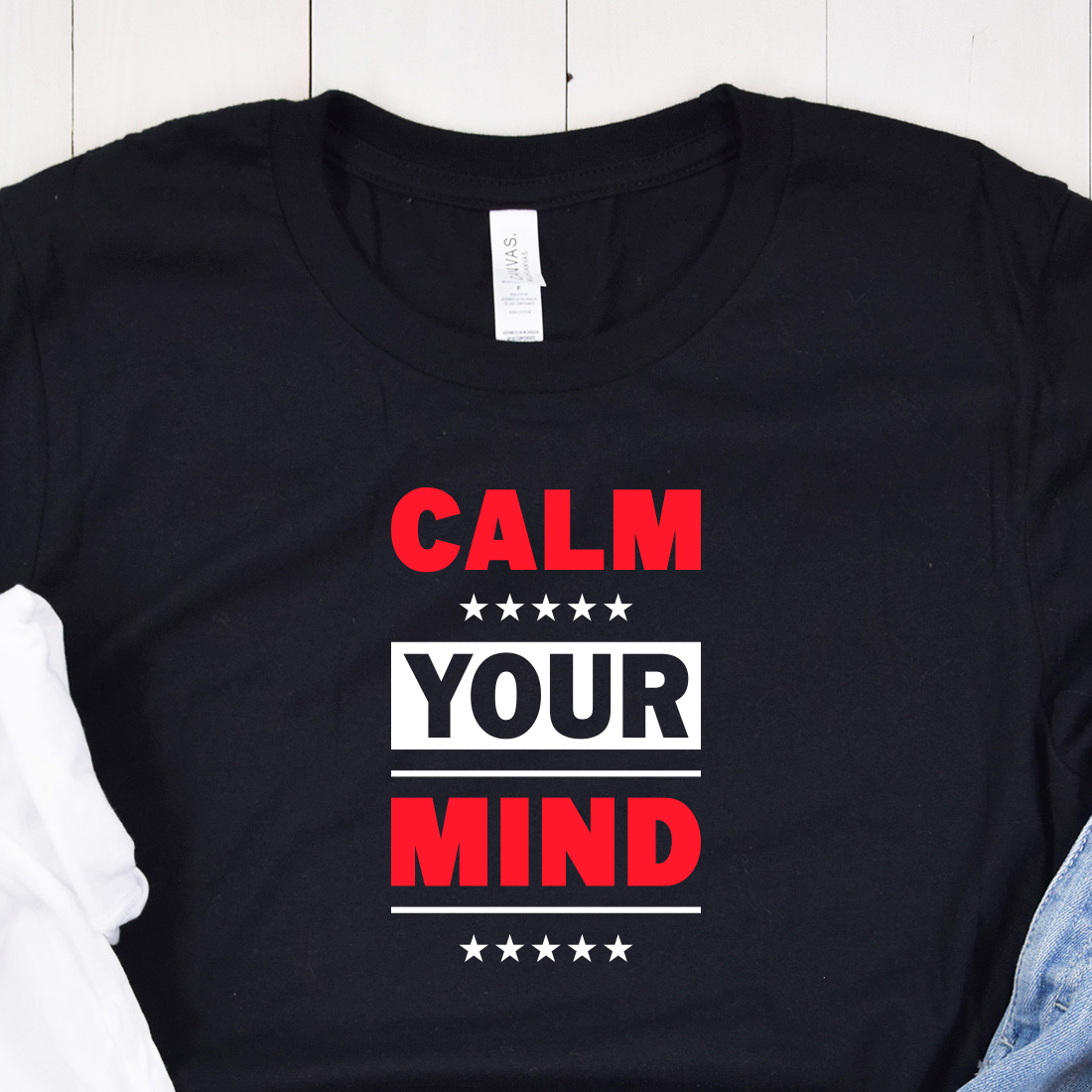 Image of a black t-shirt with an irresistible slogan "Calm your mind" in white and red.