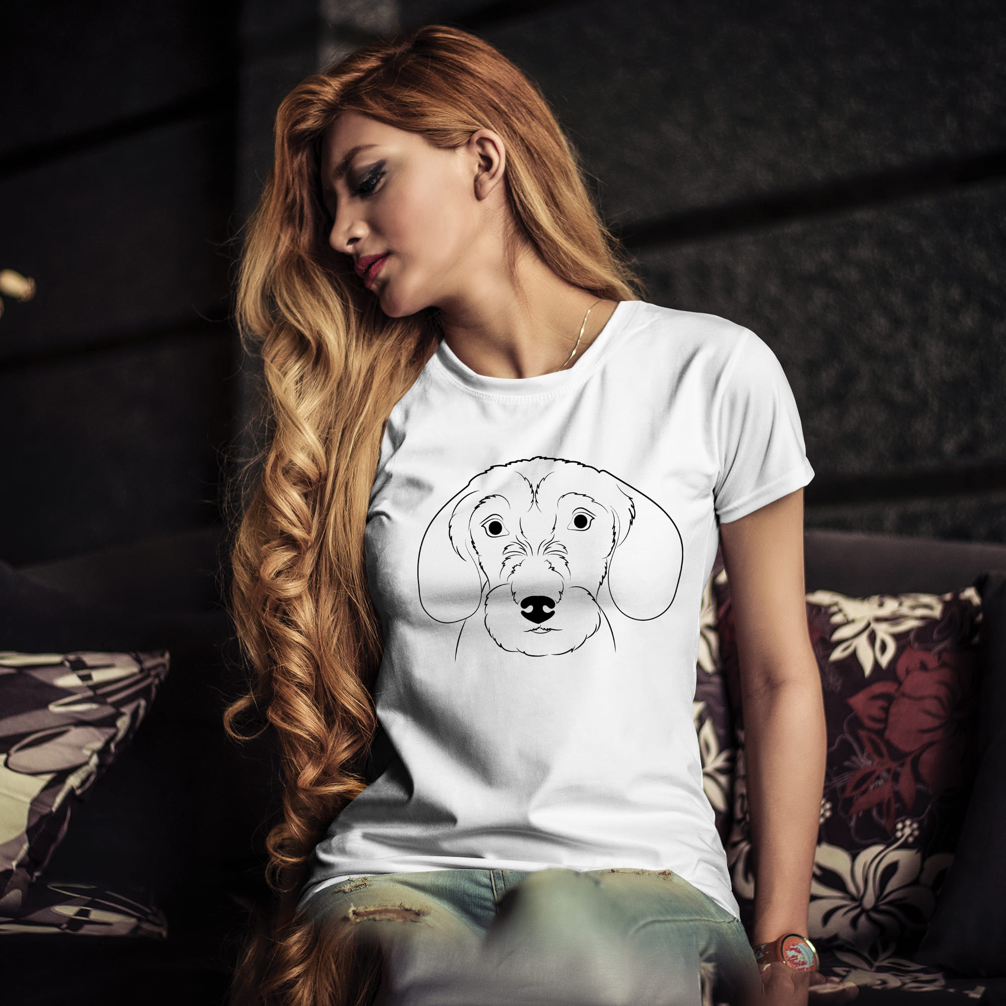 Woman sitting on a couch with a dog t - shirt on.