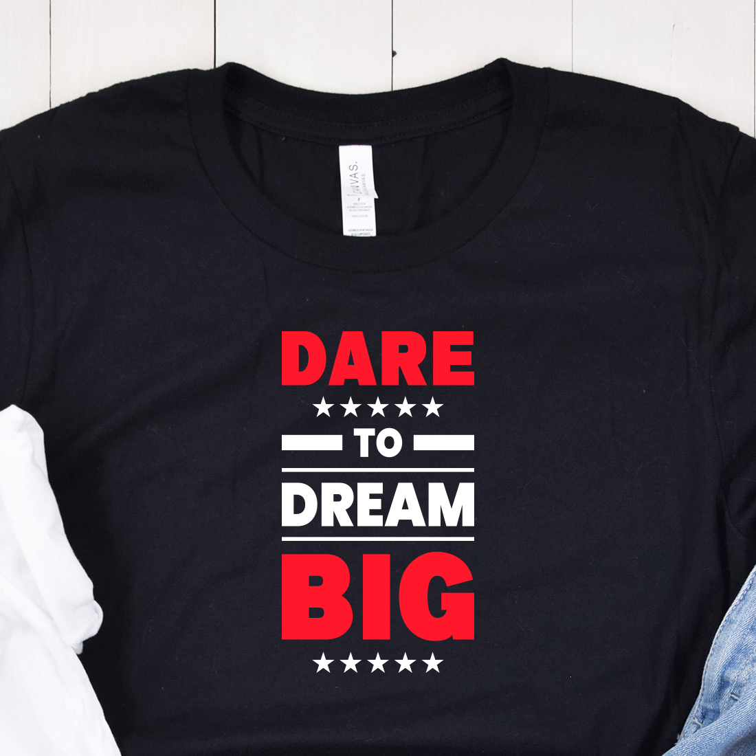 Image of a black t-shirt with a charming inscription "dare to dream big" in red and white colors.