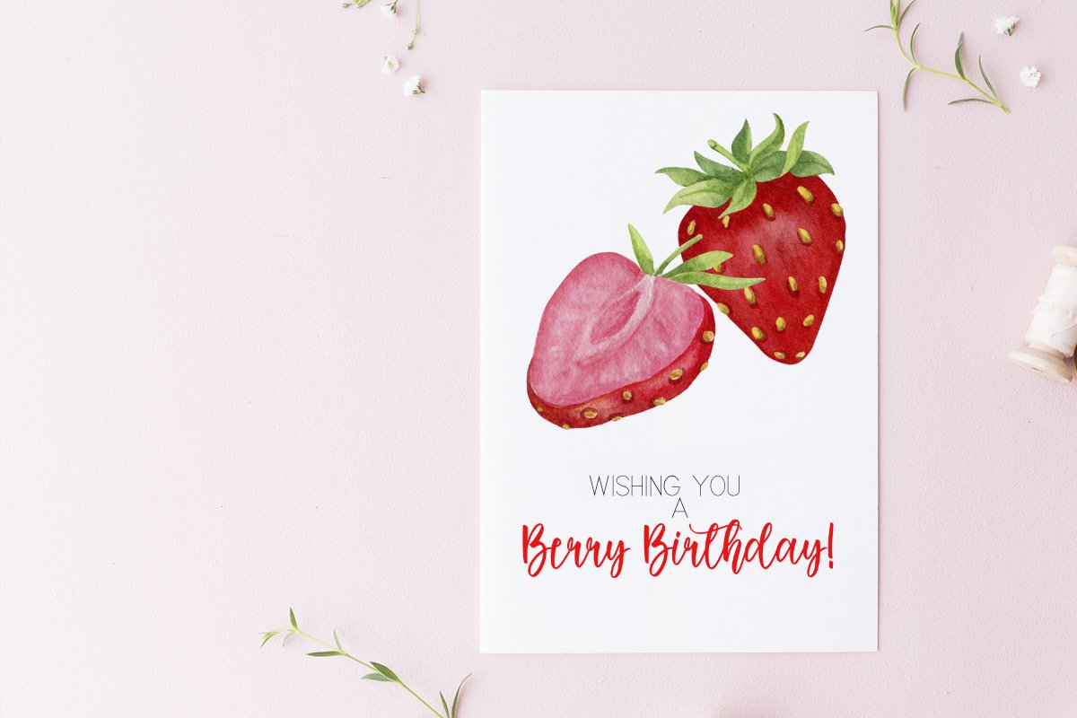 White greeting card with black-red lettering "Wishing you a Berry Birthday!" and illustration of a strawberry.