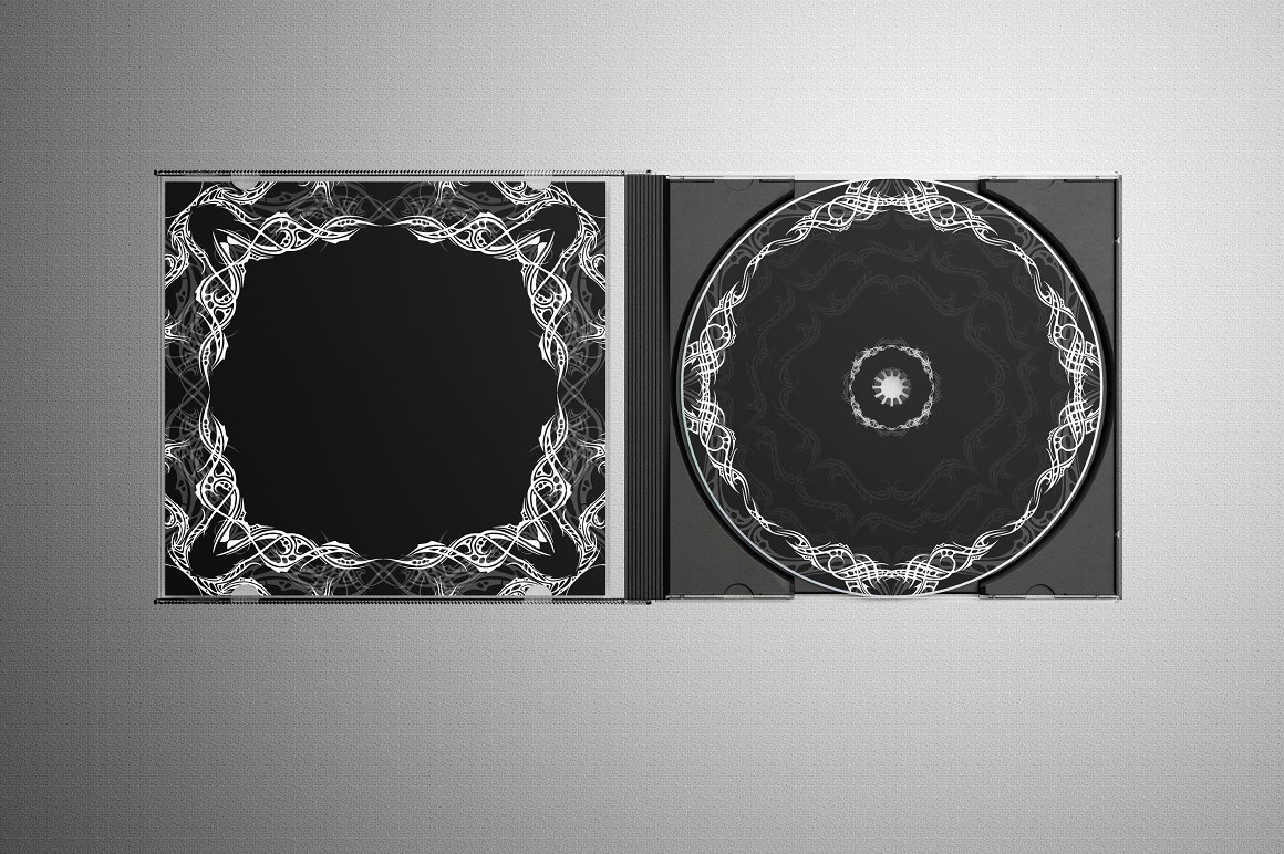 Black CD disk with white tattoo design on a gray background.